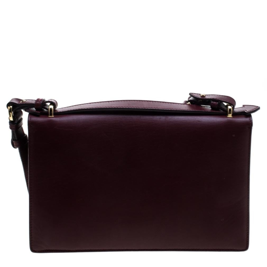 Get yourself this burgundy bag to flaunt your best side and carry it everywhere you go. Made with love is this exclusive piece of trendy accessory by Salvatore Ferragamo. Masterfully created in leather and flaunting the gold-tone signature Gancio