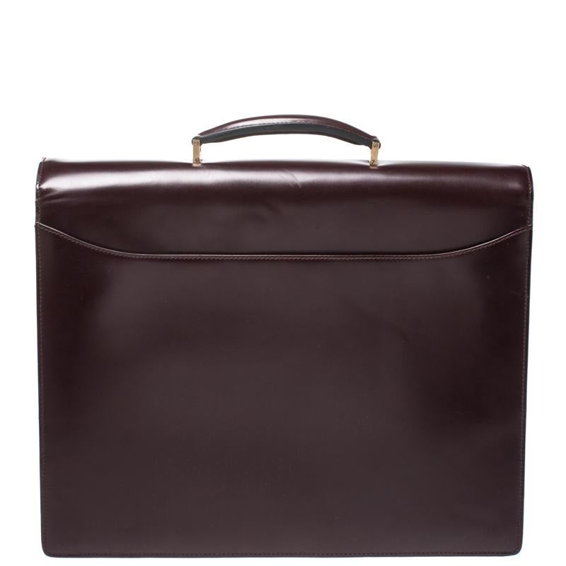 This Salvatore Ferragamo briefcase brings such a fantastic design that you're sure to look fashionable whenever you carry it. It has been crafted from burgundy leather and designed with a top handle, a gold-tone lock and a flap that leads to a