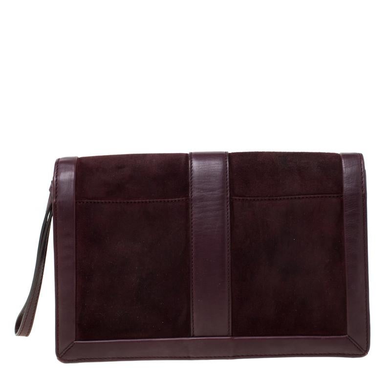 Crafted from suede and leather, this clutch by Salvatore Ferragamo comes with a signature lock on the flap, and a fabric interior with a zip compartment for your essentials. The clutch brings a lot of charm to accompany your evening outfits.


