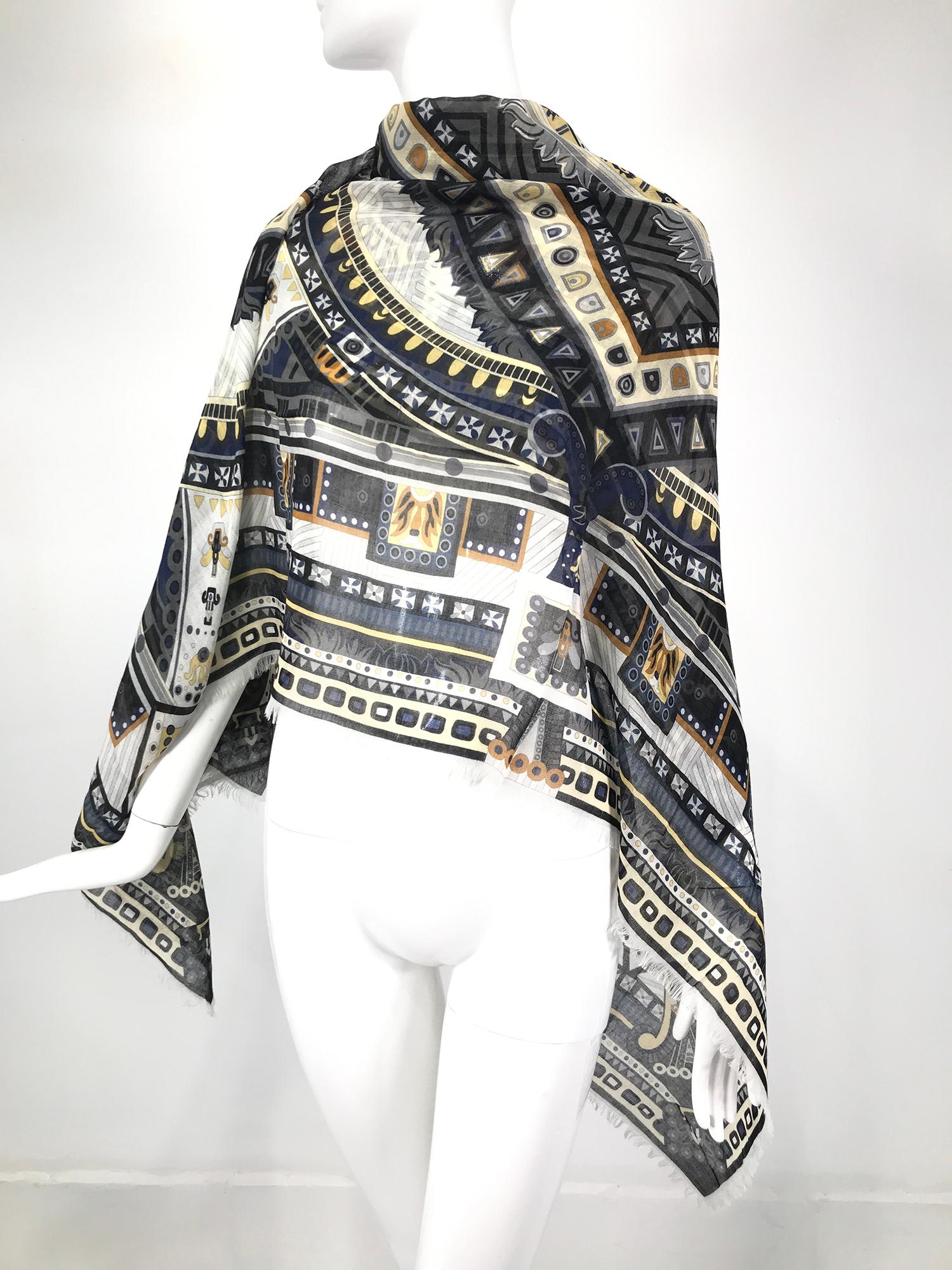 Salvatore Ferragamo cashmere & silk geometric print shawl with a narrow self fringe. This beautiful shawl is light as air and warm as toast. The design is bold in greys and black with touches of gold. The large size works as a shawl for evenings and