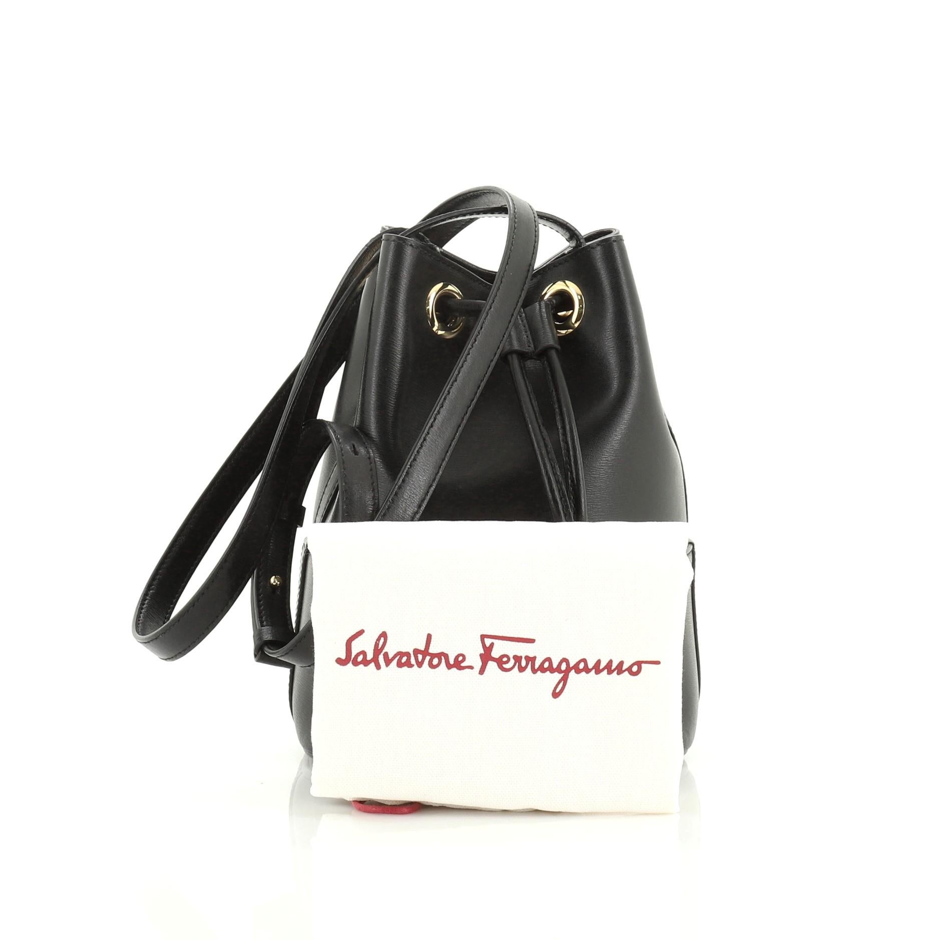 This Salvatore Ferragamo City Bucket Bag Leather Small, crafted from black leather, features an adjustable leather strap, protective base studs and gold-tone hardware. Its drawstring closure opens to a black microfiber interior.

Estimated Retail