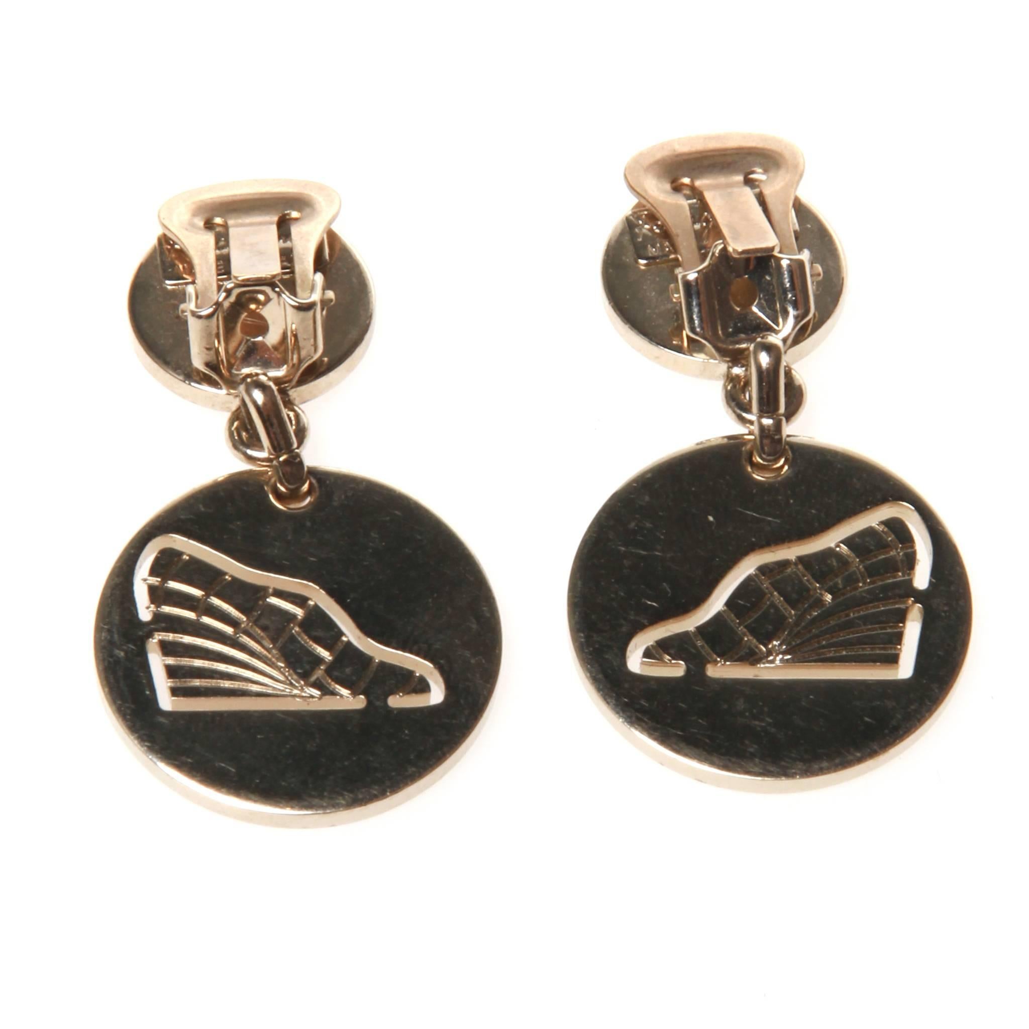 Salvatore Ferragamo clip on earrings in silver-tone metal featuring a drop design with cut-out image. 