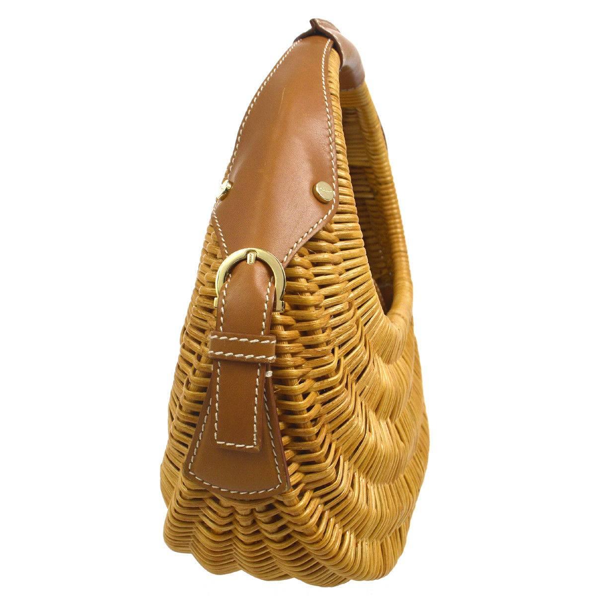 Salvatore Ferragamo Cognac Basket Weave Gold Top Handle Satchel Evening Picnic Bag

Wicker
Gold tone hardware
Woven lining
Made in Italy
Handle drop 5