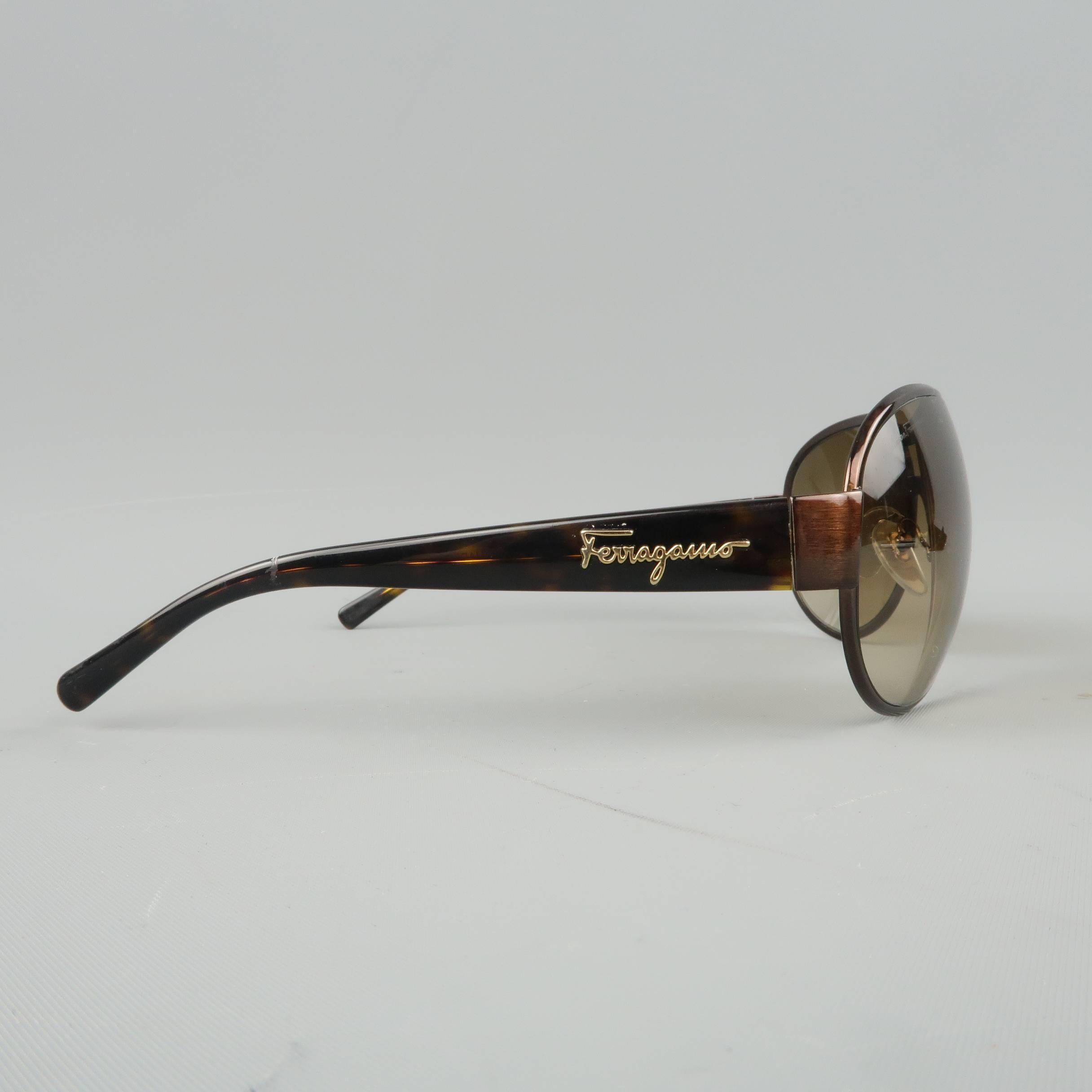 SALVATORE FERRAGAMO aviator sunglasses come in copper tone metal with tan lenses and tortoise pattern acetate arms with gold tone logo. With case. Made in Italy.
 
Excellent Pre-Owned Condition.
Marked: 1132 578/13 67-13 120
 
Measurements:
