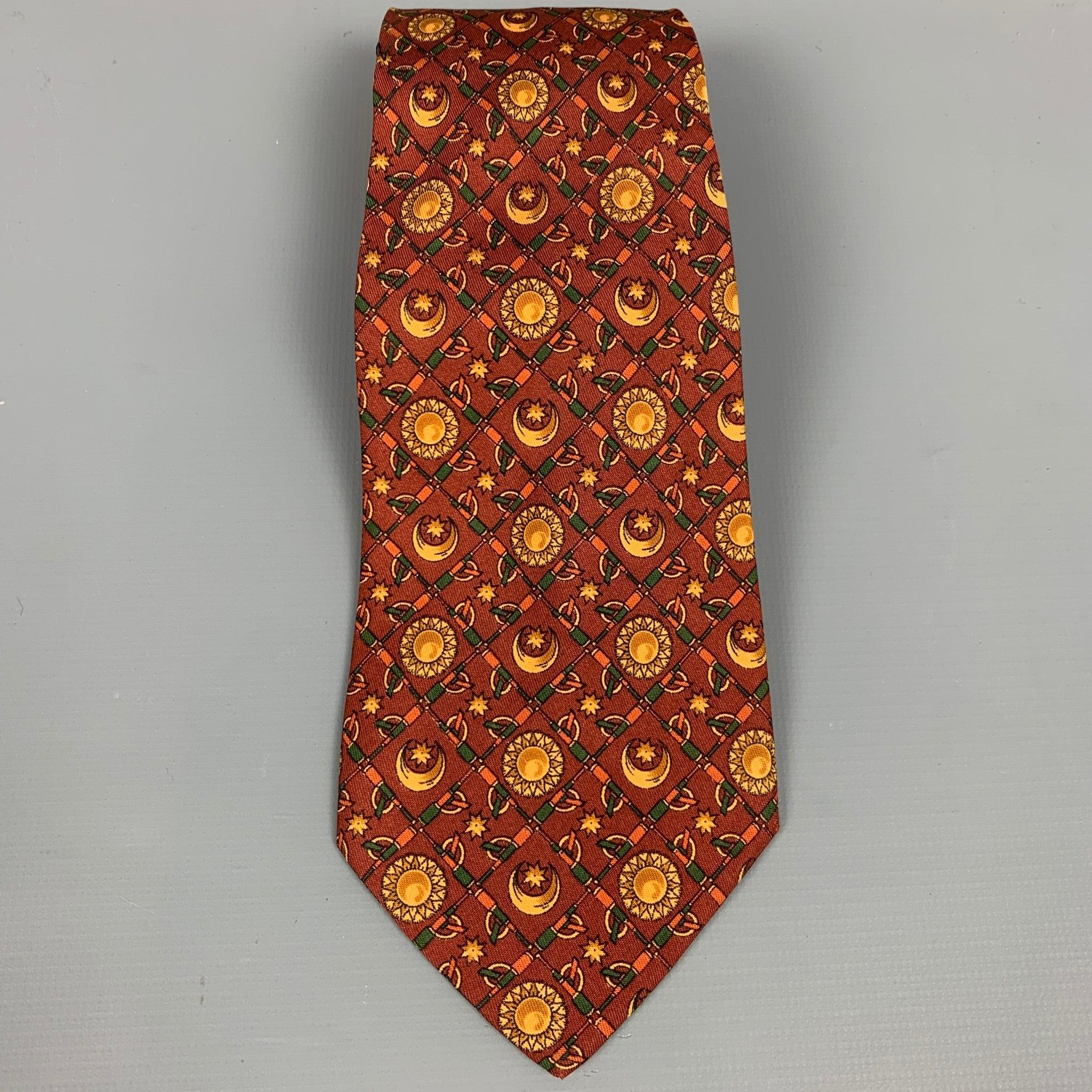 SALVATORE FERRAGAMO neck tie comes in a copper sun & moon print silk. Made in ItalyVery Good Pre-Owned Condition. 

Measurements: 
  Width: 3.5 inches  
  
  
 
Reference: 51293
Category: Tie
More Details
    
Brand:  SALVATORE FERRAGAMO
Color: 