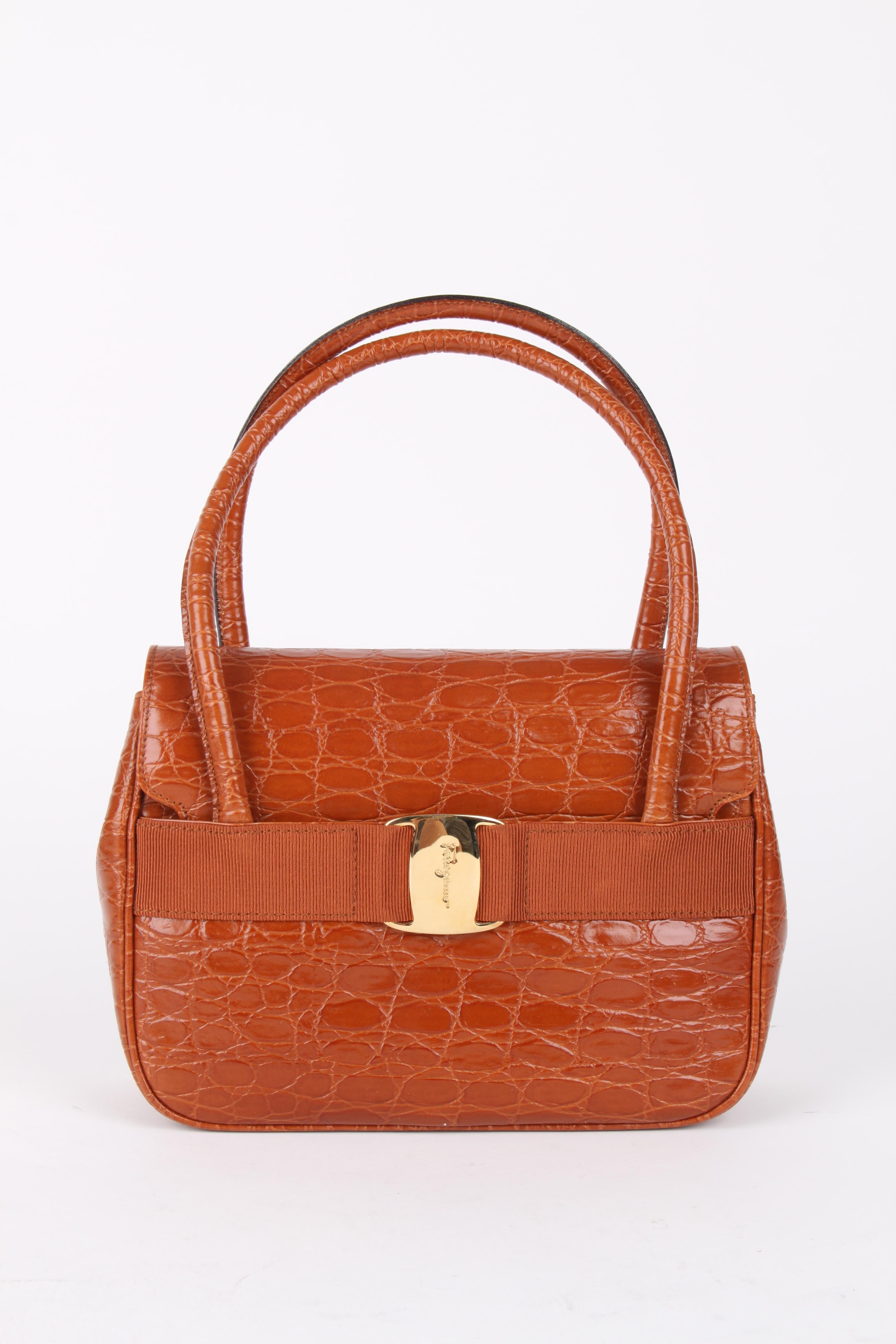 Salvatore Ferragamo Crocodile Embossed Crossbody Bag.

 Brown leather gold-tone hardware with logo stamp on the front with grosgrain trim, leather crossbody strap and top zip closure. The interior is fully lined in jacquard lining featuring a slip