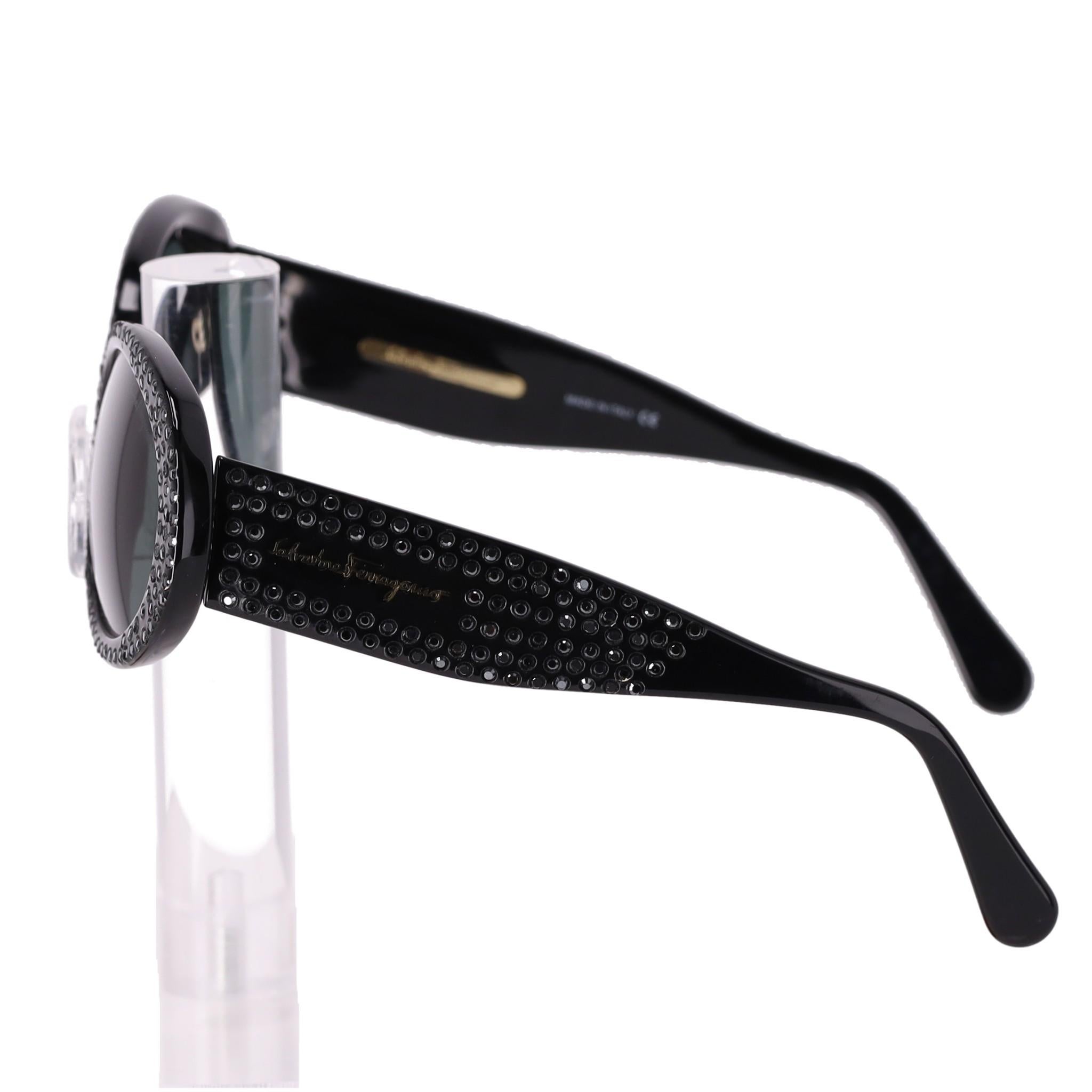 Salvatore Ferragamo Crystal Frames Sunglasses

Black retro sunglasses with crystal encrusted frames.

Featuring grey lenses and 'Salvatore Ferragamo' gold branding to the wide arm.

Size – One Size

Condition – Very Good (Minor scratch on the lens,