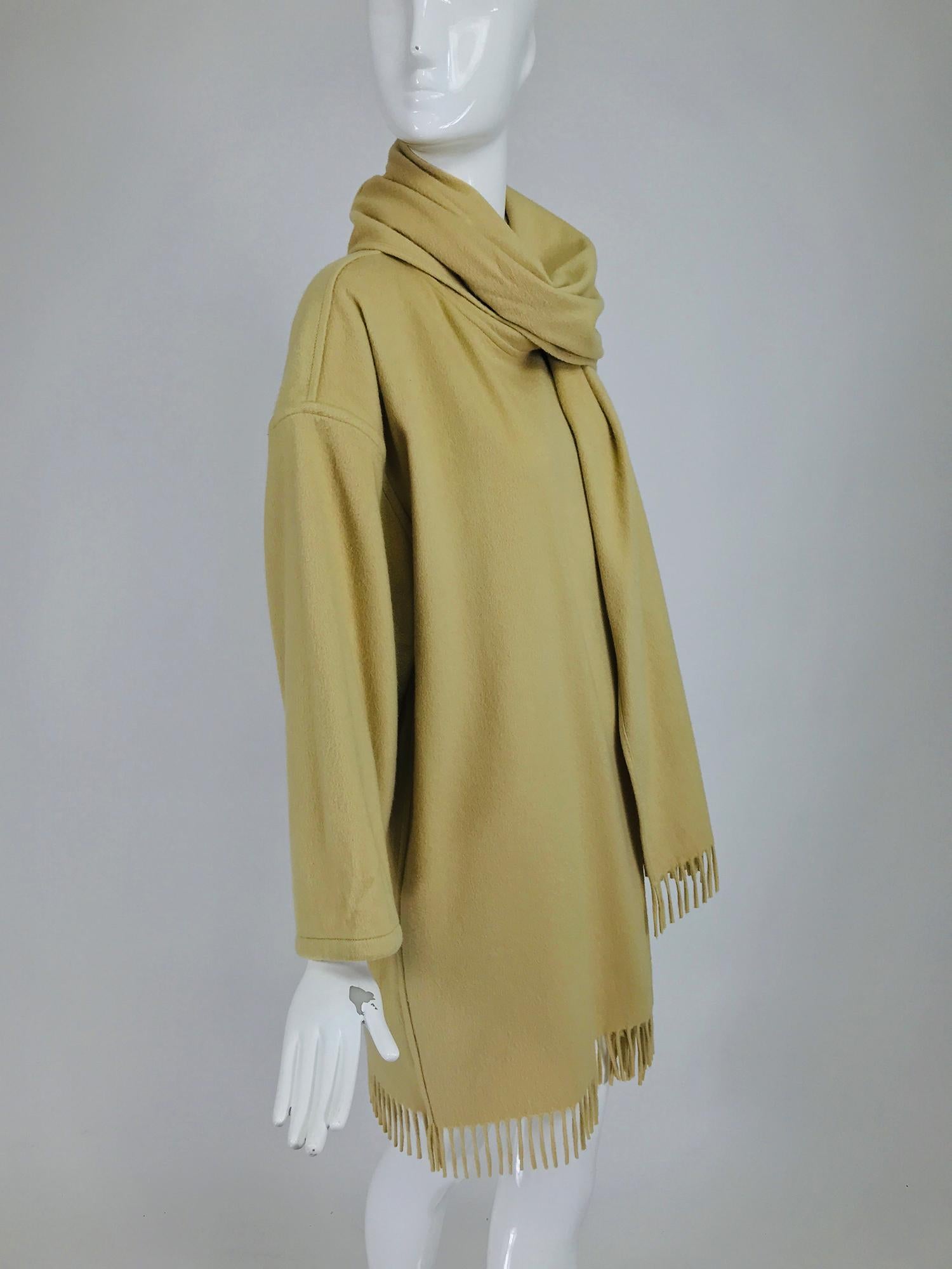 Salvatore Ferragamo double face cashmere fringe coat in creamy taupe from the 1980s. Unlined open front coat with flat felled seams. The neckline has an attached wide shawl collar each end has self fringe. The dropped sleeves are cut wide and