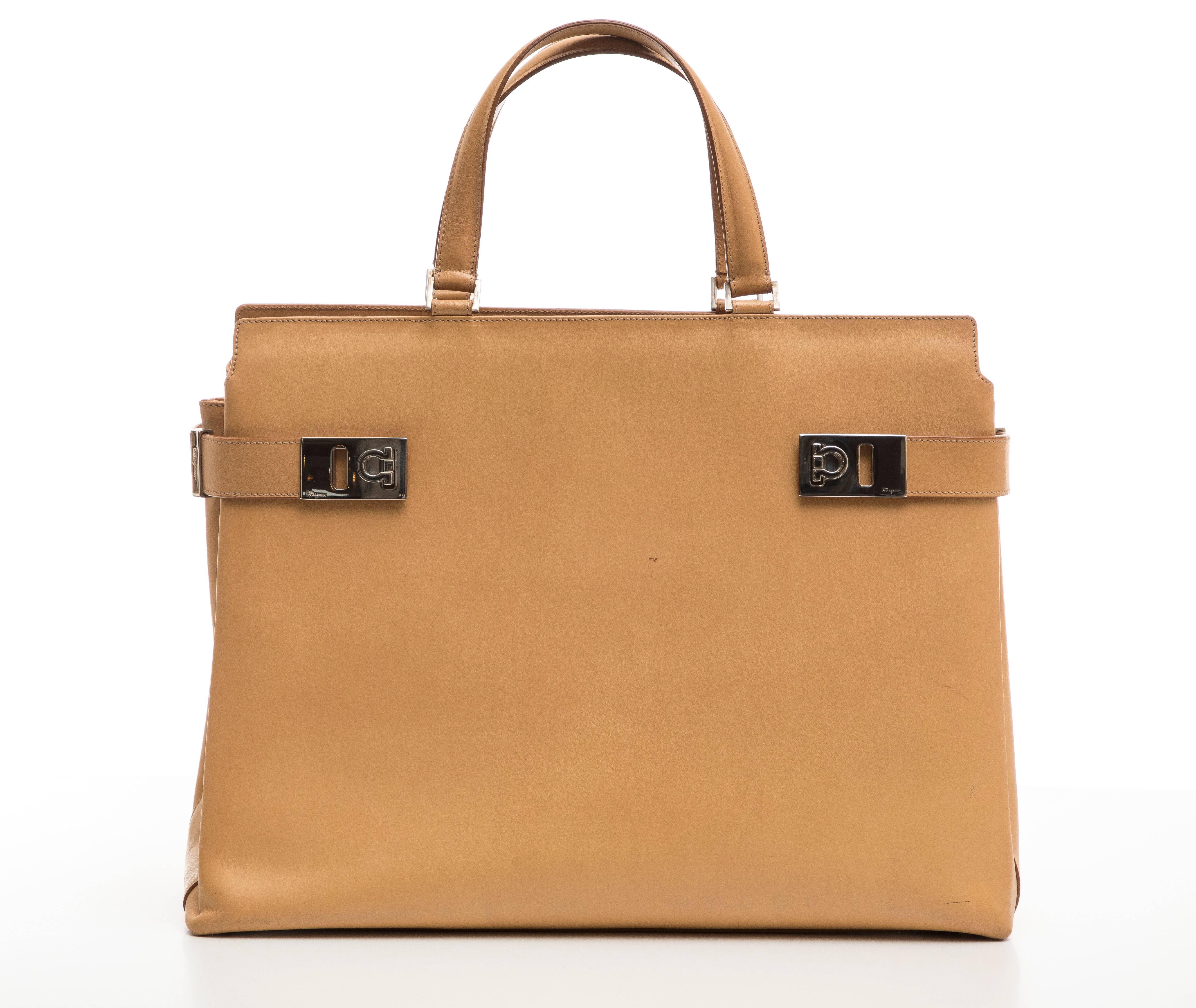 Salvatore Ferragamo butterscotch leather handbag with interior zip pocket and attached shoulder strap. Includes dust bag.

Height: 11, Width 15, Depth 6

