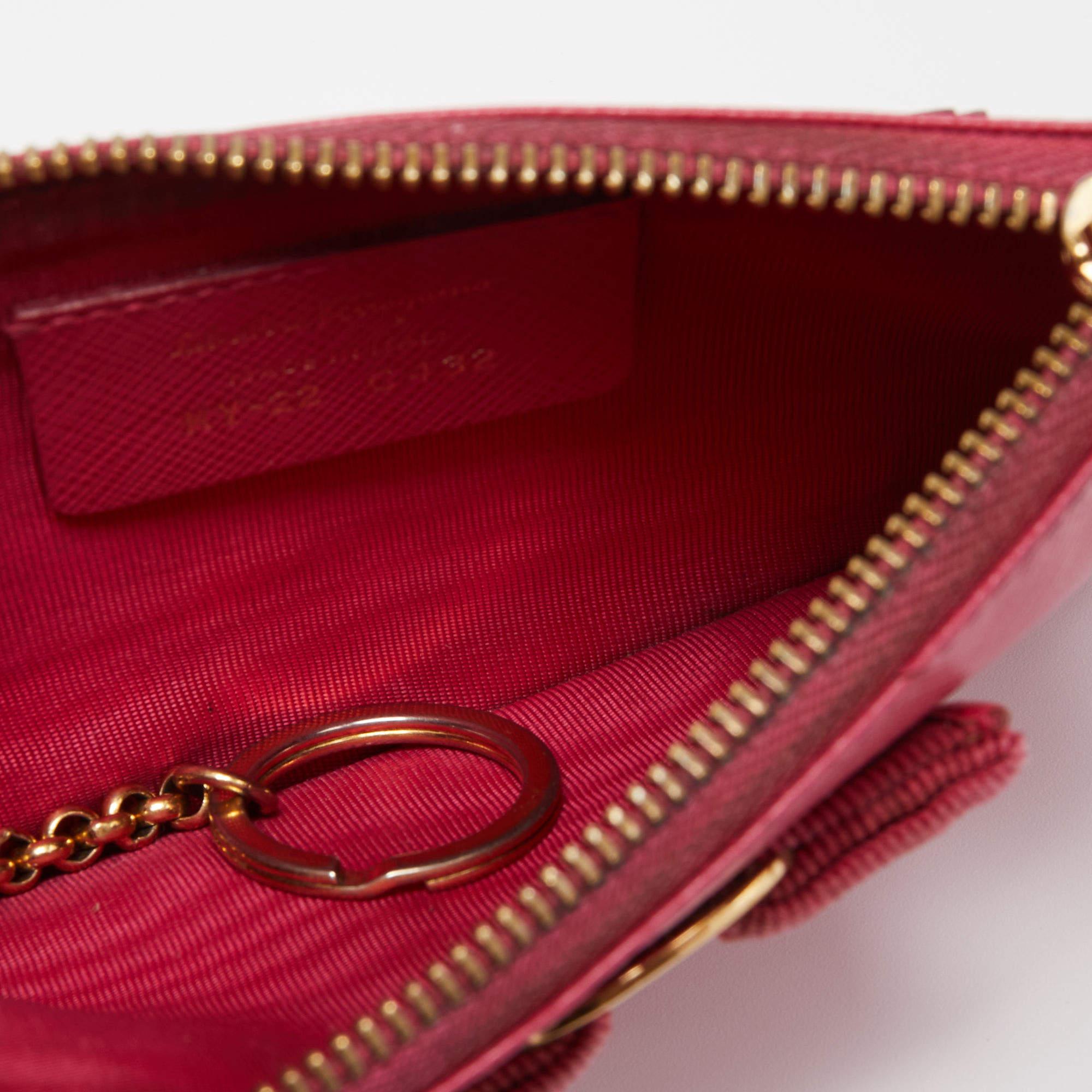 Salvatore Ferragamo marks a signature touch to this leather pouch. It flaunts the iconic logo on the front and a nylon lined interior that is well sized.