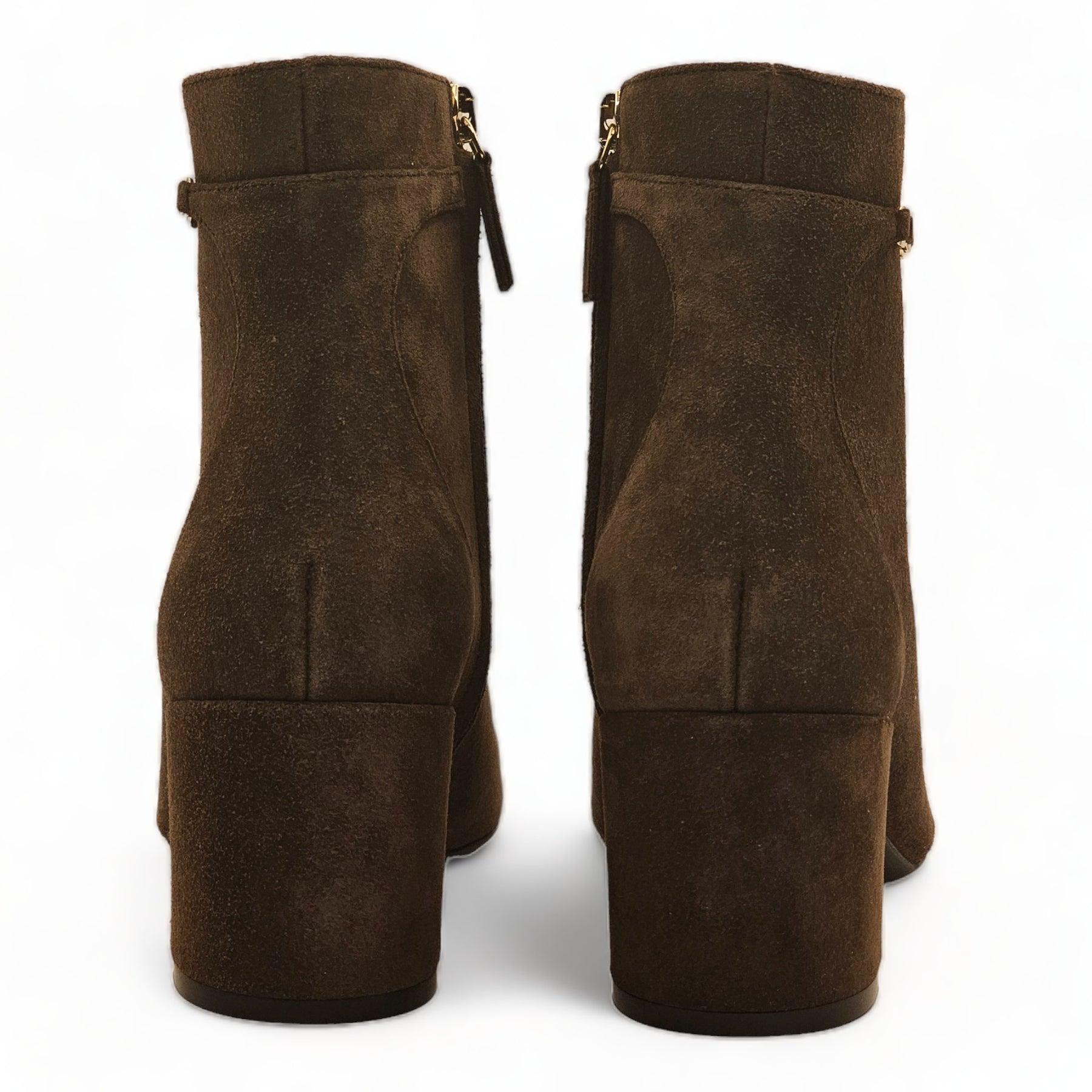 Supple suede ankle boots feature a side zip with tab and a vara chain for flair.

Additional information:
Material: Suede upper, Almond toe, Zip closure, Leather lining, Leather sole, Dry clean.
Color: Brown
Size: True to size Heel, about 2.25”