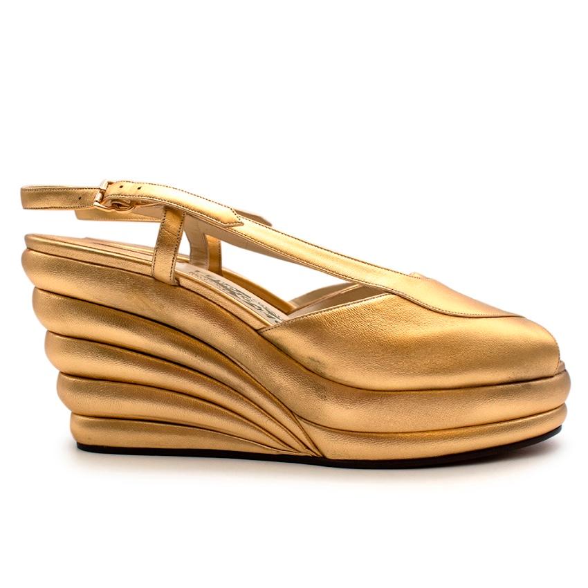 Salvatore Ferragamo Gold Leather Dotted Limited Ed. 1942 Wedge Shoes

Limited numbered re-edition of the Salvatore Ferragamo archives. This style was designed in 1942 and this pair is numbered the 75/1000.

- Made of soft leather 
- Gold tone 
-