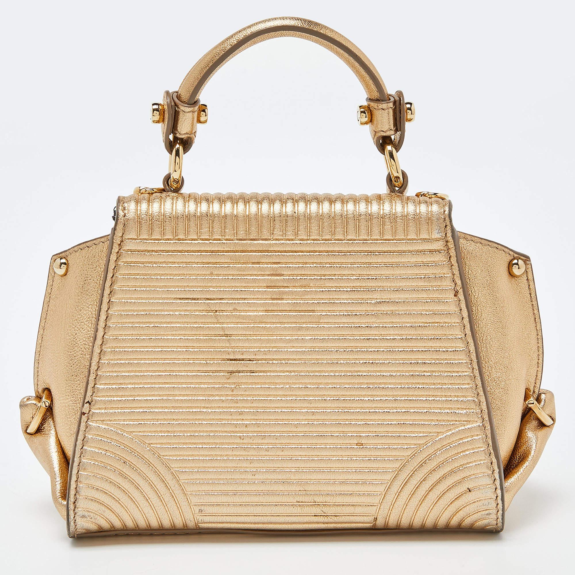 A beautifully made bag that can be used with both day and evening looks, this Salvatore Ferragamo Mini Sofia bag will never fail to impress you. Crafted in gold leather, this bag features a top leather handle and long strap for your convenience.