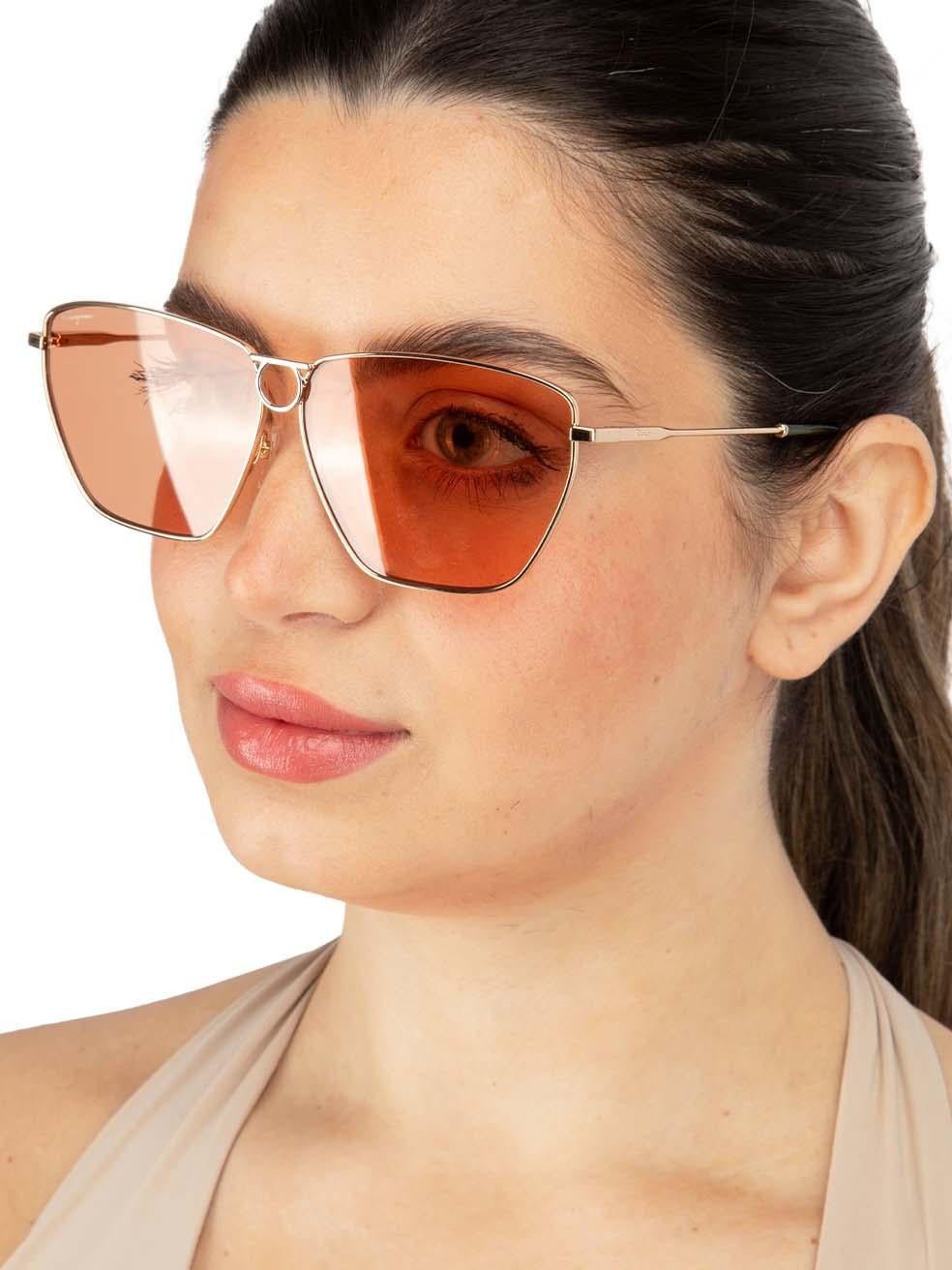 CONDITION is New with tags on this brand new Salvatore Ferragamodesigner item. This item comes with original packaging.
 
 
 
 Details
 
 
 Model: SF240S 789
 
 Gold
 
 Metal
 
 Square Eye Sunglasses
 
 Gold Metal Frame
 
 Tinted Orange Lens
 

