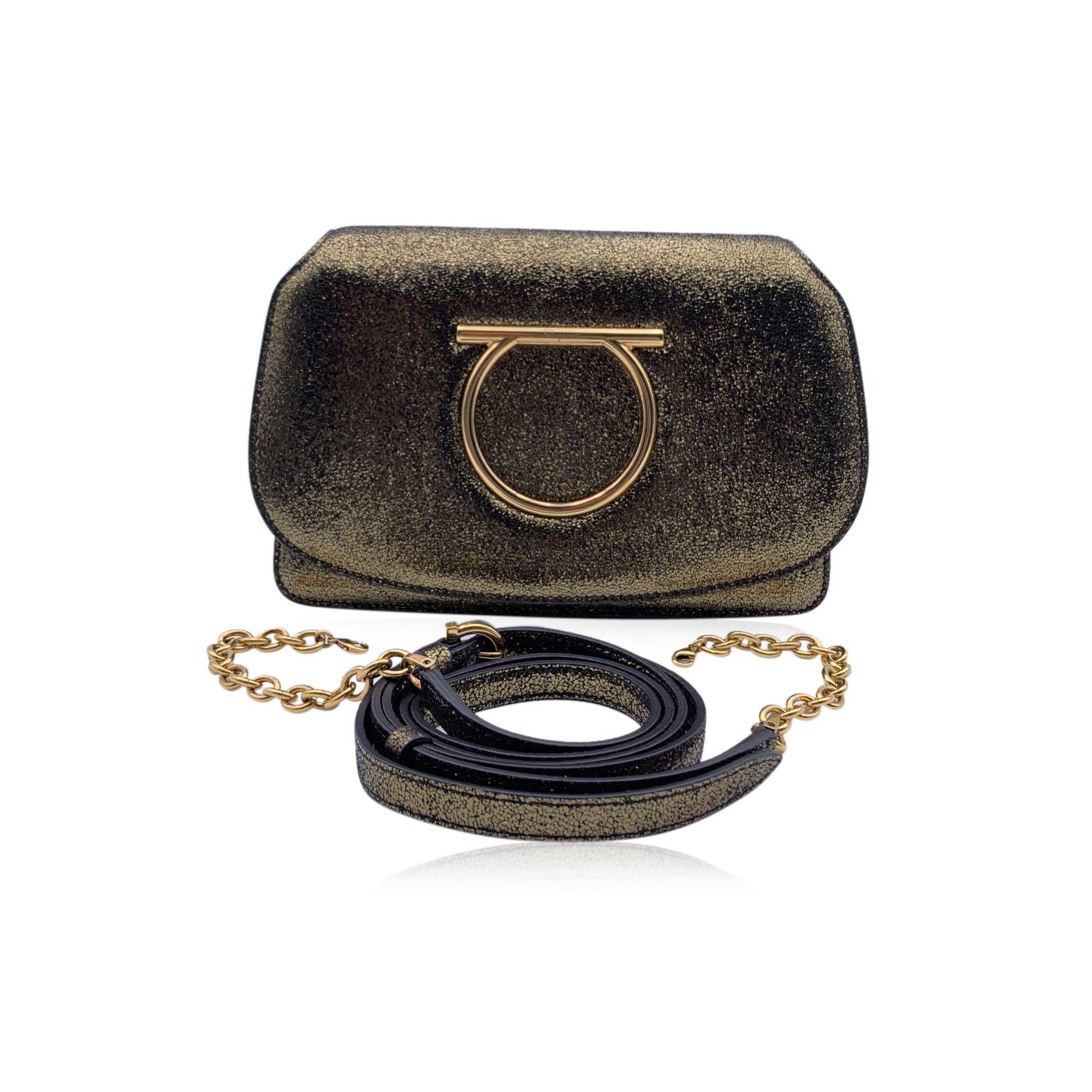 Beautiful 'Gancino' crossbody bag by Salvatore Ferragamo. Made of gold tone goat leather. It features the Gancino logo detailing on the front in gold metal. Flap with magnetic button closure. Adjustable and removable leather shoulder strap. Can be