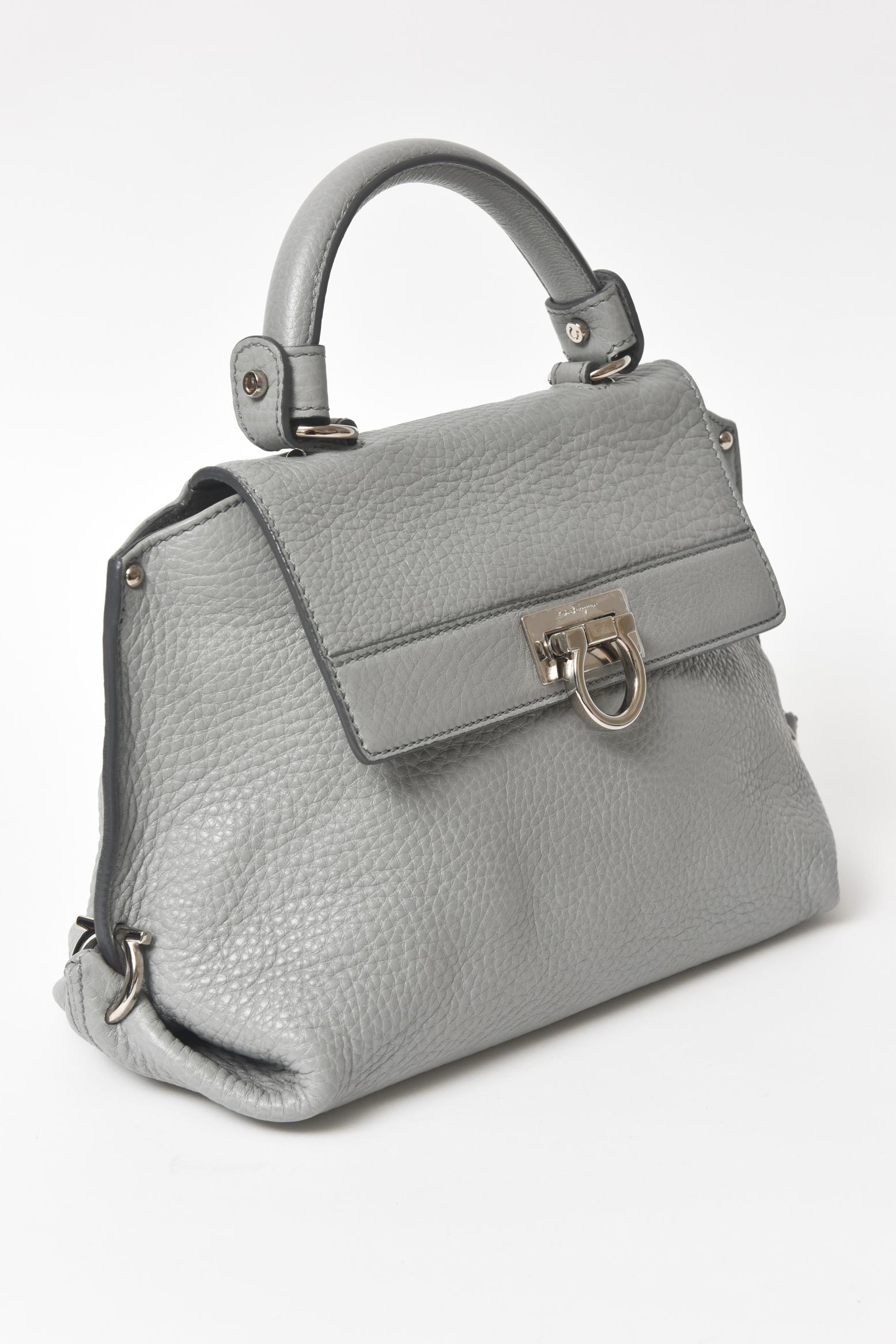 Feminine and versatile, iconic Sofia bag has been made in a compact size for an elegant look. Crafted from pebbled calf leather, it is lined with tonal jacquard lining and has aback zipper  pocket. Complete with silver-toned Gancini flip -lock