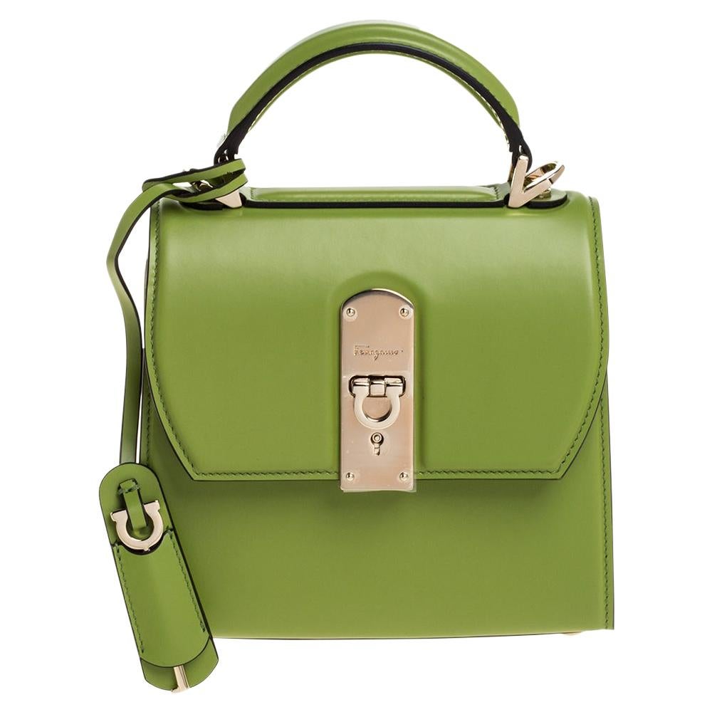 Distinctive in design and style, this Boxyz bag from Salvatore Ferragamo definitely deserves to be yours! It has been crafted from green leather and features a single top handle with an attached clochette and the brand logo engraved signature lock