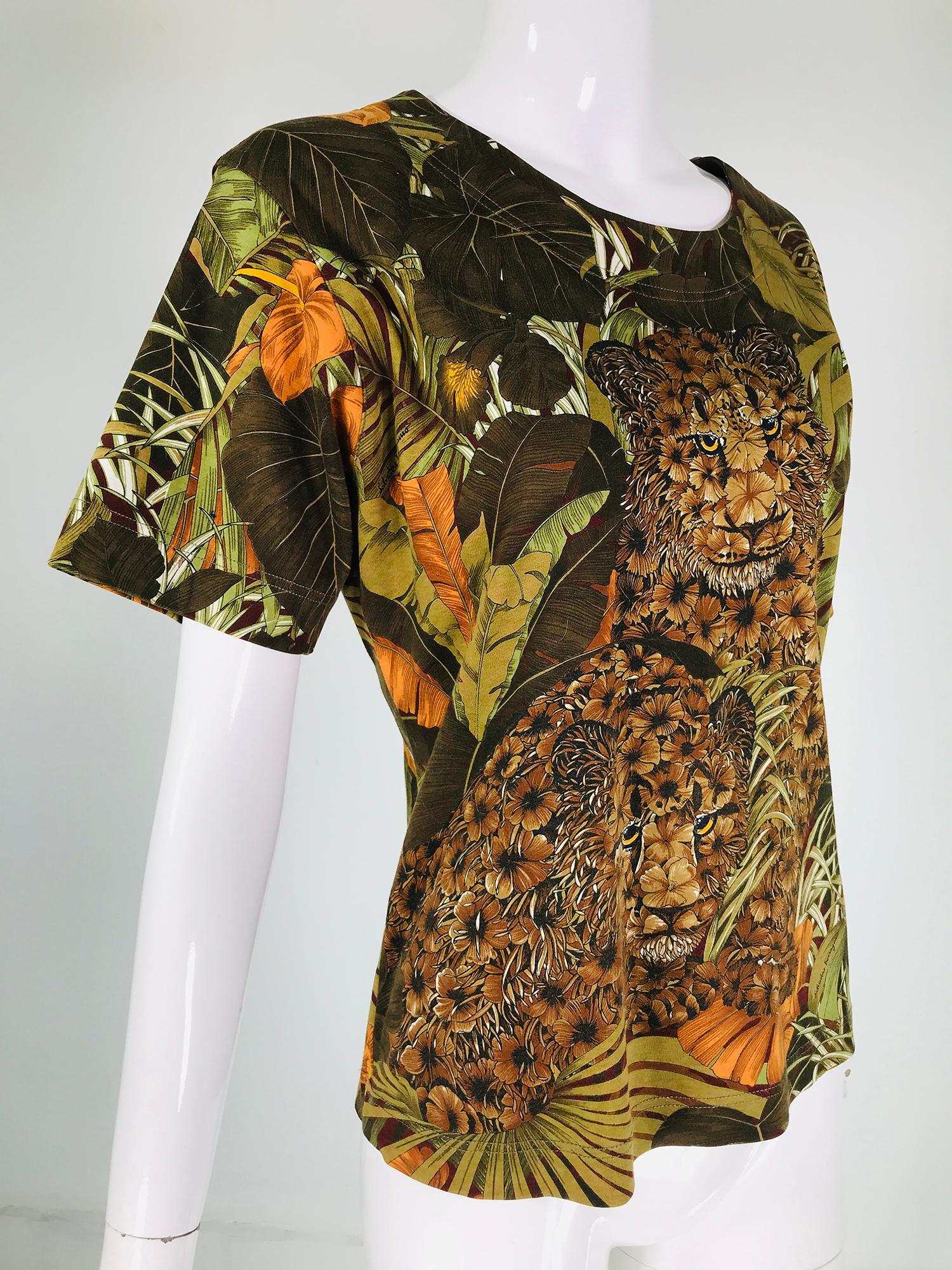 Salvatore Ferragamo jungle cats cotton knit short sleeve shirt. Pull on shirt with finished neck, sleeves & hem in medium weight fine cotton. The print is in shades of greens, browns & oranges, with jungle flora & fauna, center front is a fantasy