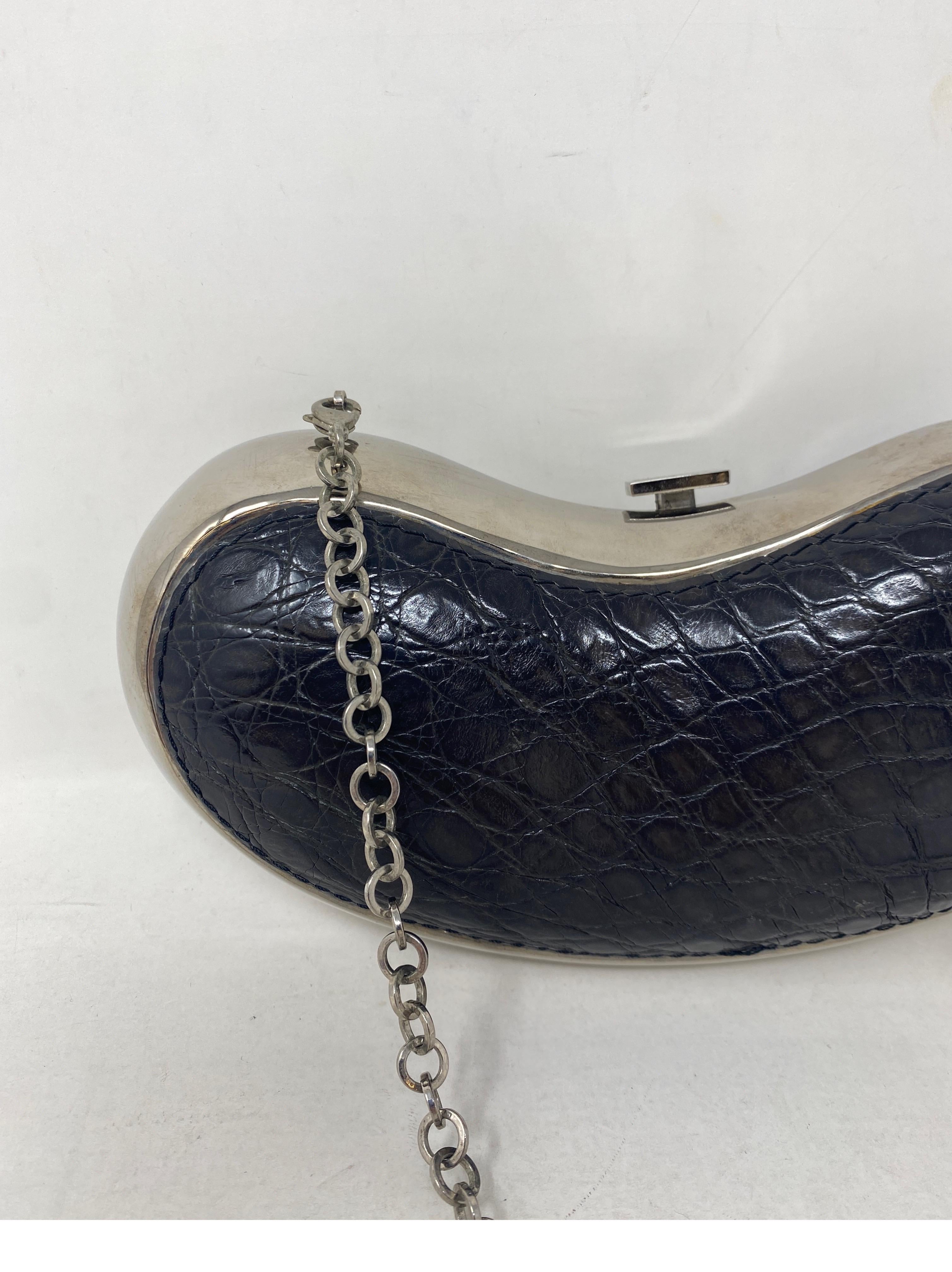 Salvatore Ferragamo Kidney Bean Shape Alligator Leather Bag. Black alligator embossed leather. Silver metal bag. Unique and rare style. Collector's piece. Can be worn as a shoulder bag or as a clutch. Guaranteed authentic. 