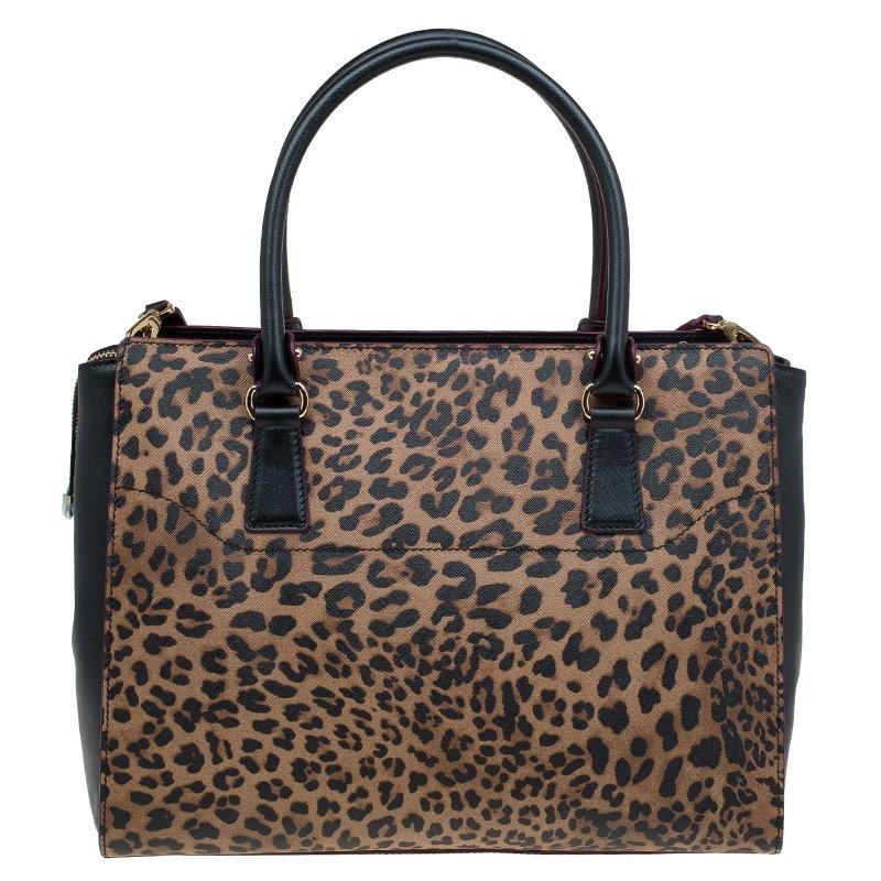 Salvatore Ferragamo’s Beky tote is rendered in a large structured silhouette with leopard print textured leather and polished Gancini hardware. It features expandable snap gussets and a spacious three-section interior with multiple pockets. The