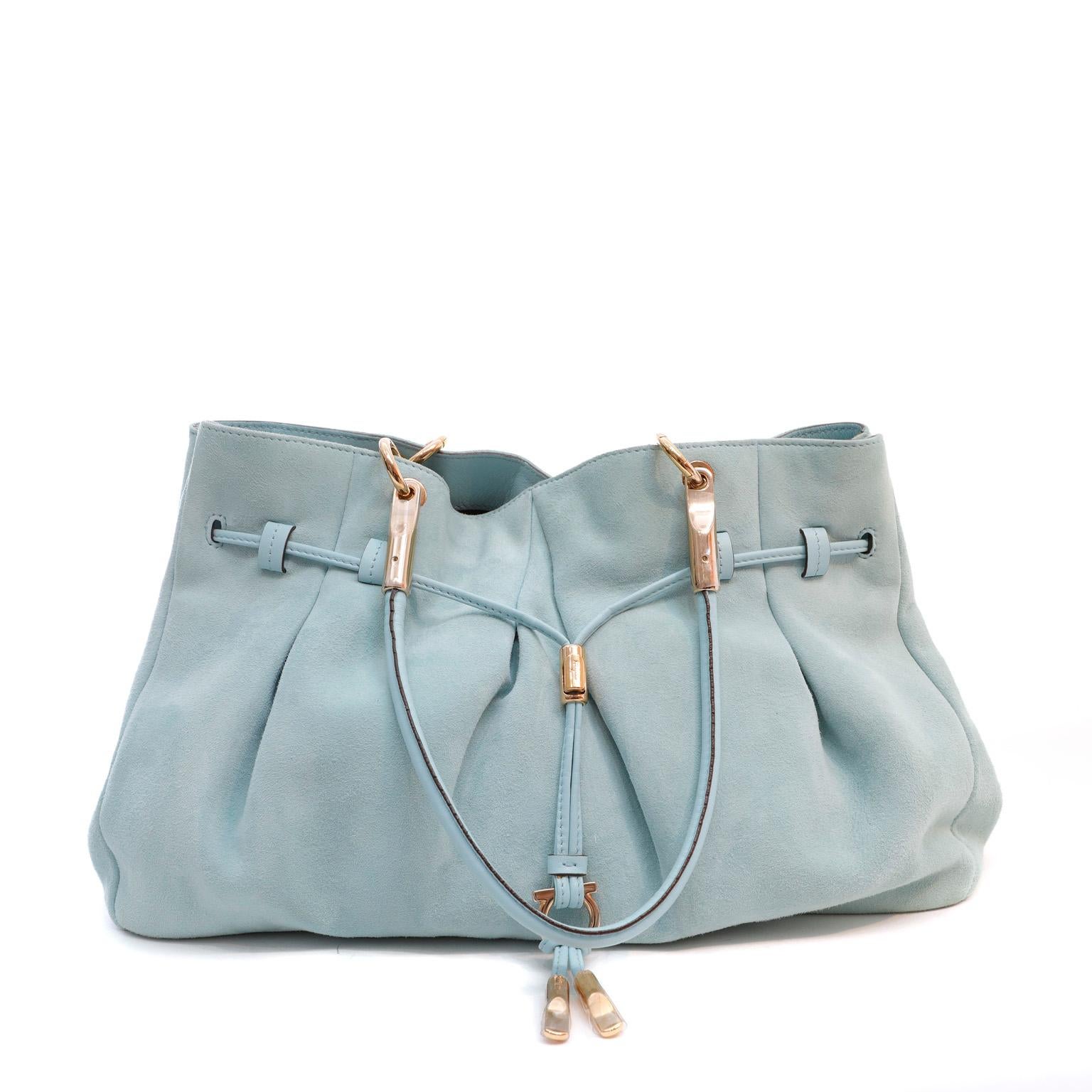 This authentic Salvatore Ferragamo Light Blue Suede Hobo is in excellent condition.  Robin’s egg blue supple suede hobo with feminine pleated details and gold tone Gancini hardware. 

PBF 13417