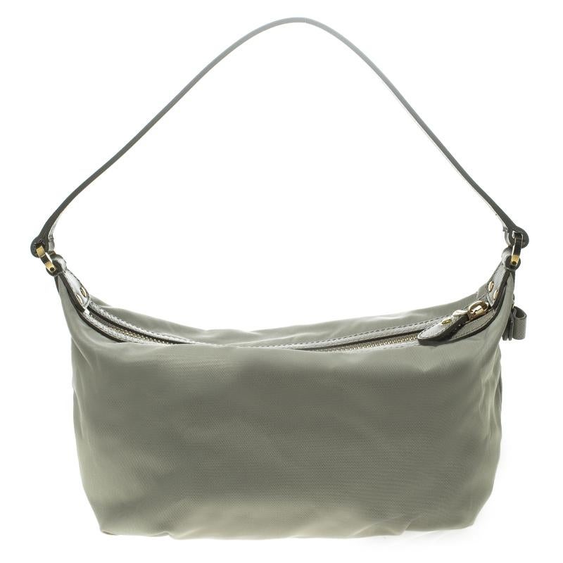 Simple, sophisticated and easy to carry, this light green hobo from Salvatore Ferragamo is a must buy! It is crafted from nylon and comes equipped with a handle strap and a top zipper that opens to a spacious interior that can easily hold all your