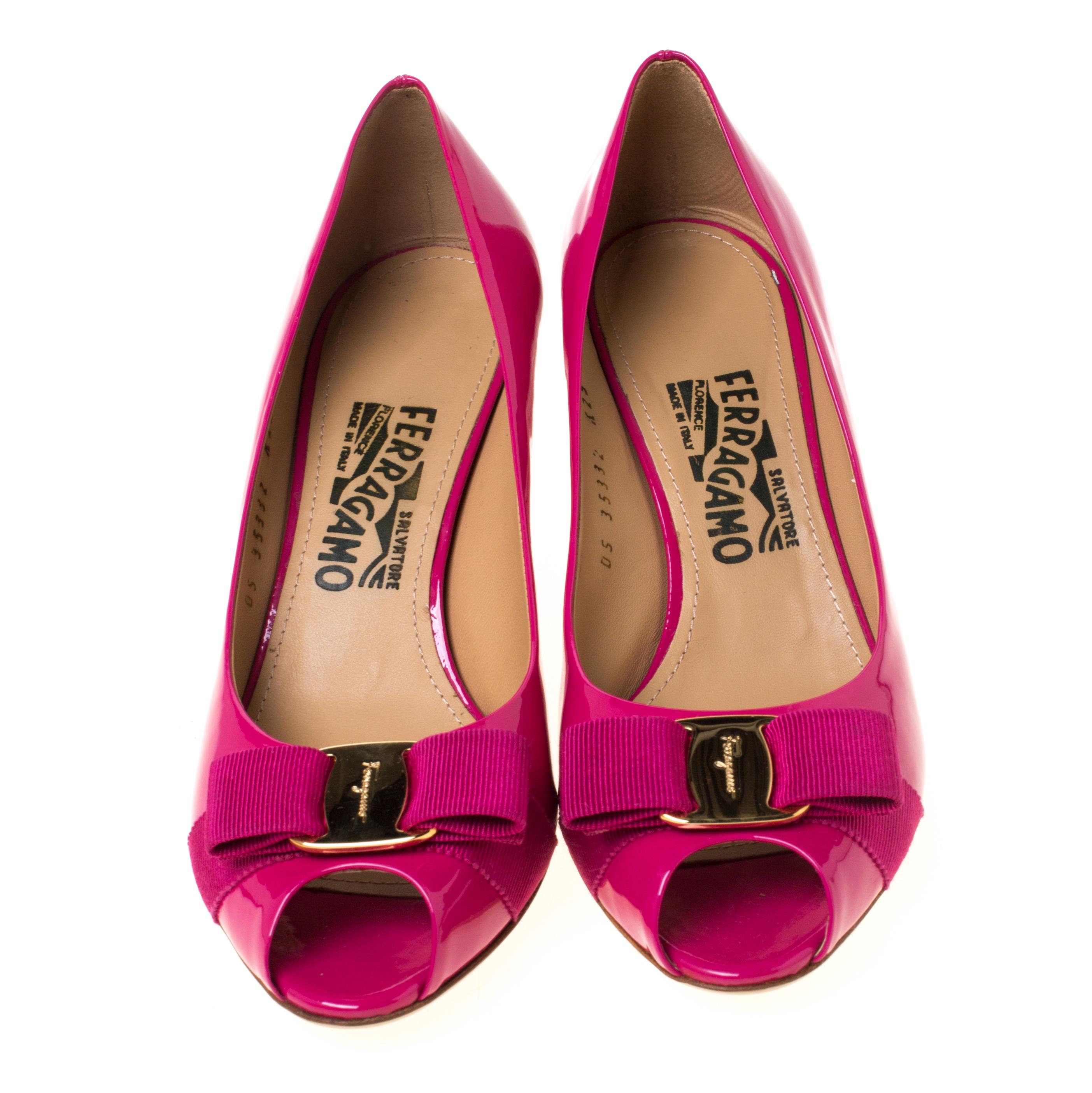 Elevate your dressing with these ‘Sissi’ wedge pumps from Salvatore Ferragamo. In an alluring peep-toe silhouette; this pair is crafted from magenta patent leather and designed with signature bows, peep-toes and wedge heels.

Includes: Original Box

