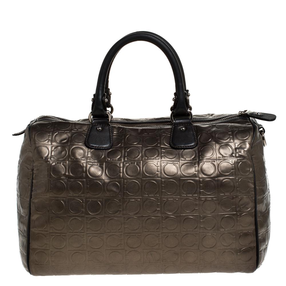 Upgrade your look with this Salvatore Ferragamo Boston bag instantly. This Gancini-embossed leather bag is fashionable and durable. It comes in a lovely shade of metallic brown. It is lined with fabric and sized for all your needs. This fashionable