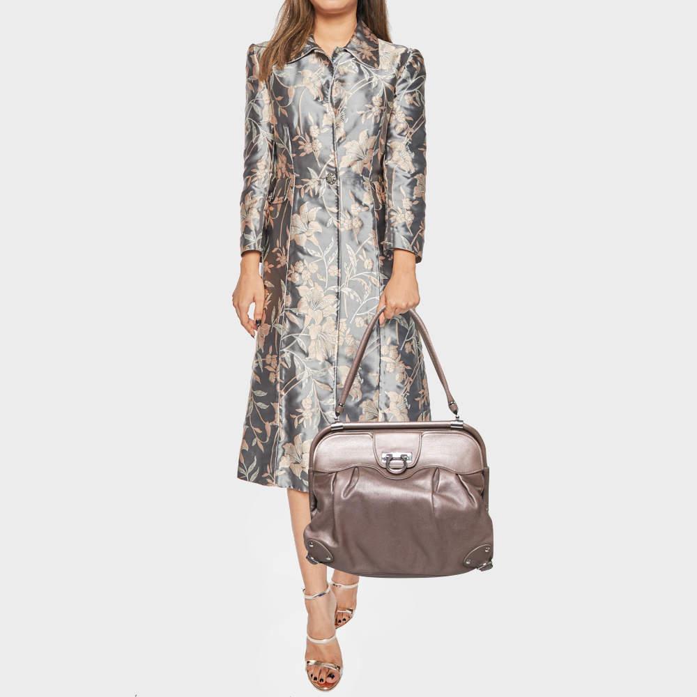 Special days call for special bags, and Salvatore Ferragamo has just the one for you. This gorgeous satchel, structured to perfection from leather, comes in a metallic brown shade. The interior has slip and zip pockets and enough space to house your