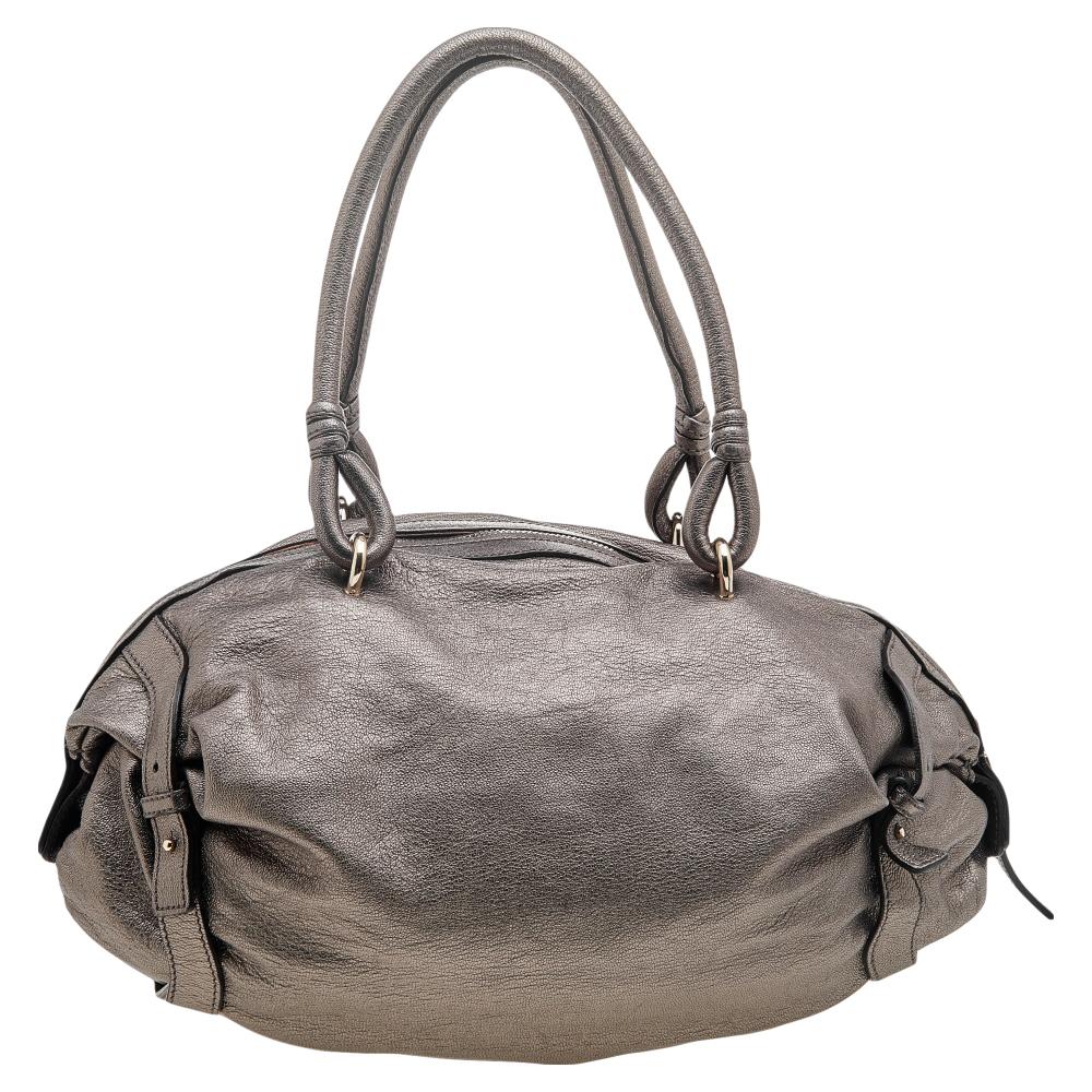 Now here's a satchel that is both stylish and functional! The House of Salvatore Ferragamo brings us this gorgeous satchel that will make you look glamorous! It is made from metallic grey leather and features a Gancini embellishment on the front. It