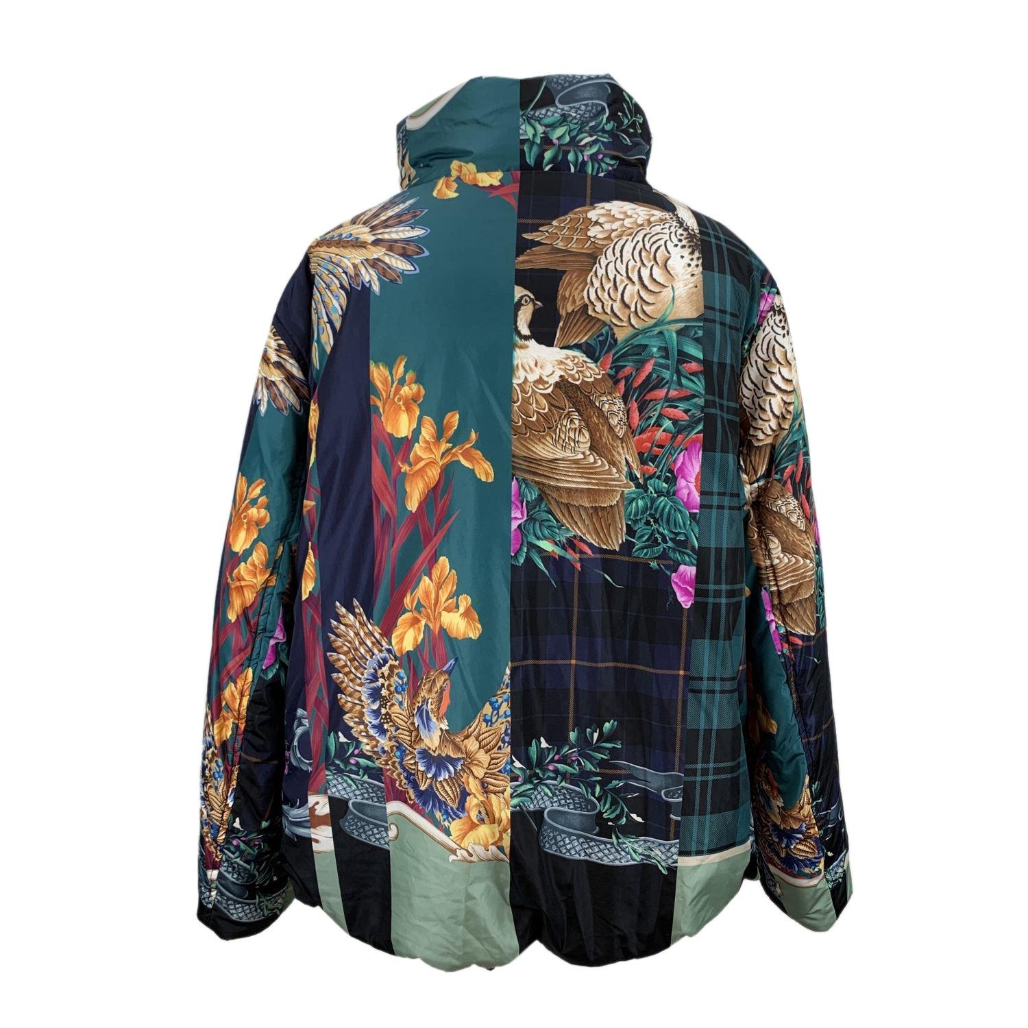 Salvatore Ferragamo multi print puffer jacket. It features a stand up collar, button closure on the front, long sleeve styling and a drawstring hem. 2 pockets on the waist. Composition: 100% Polyamide. Filling: 100% Polyester. Size: 40 IT (The size