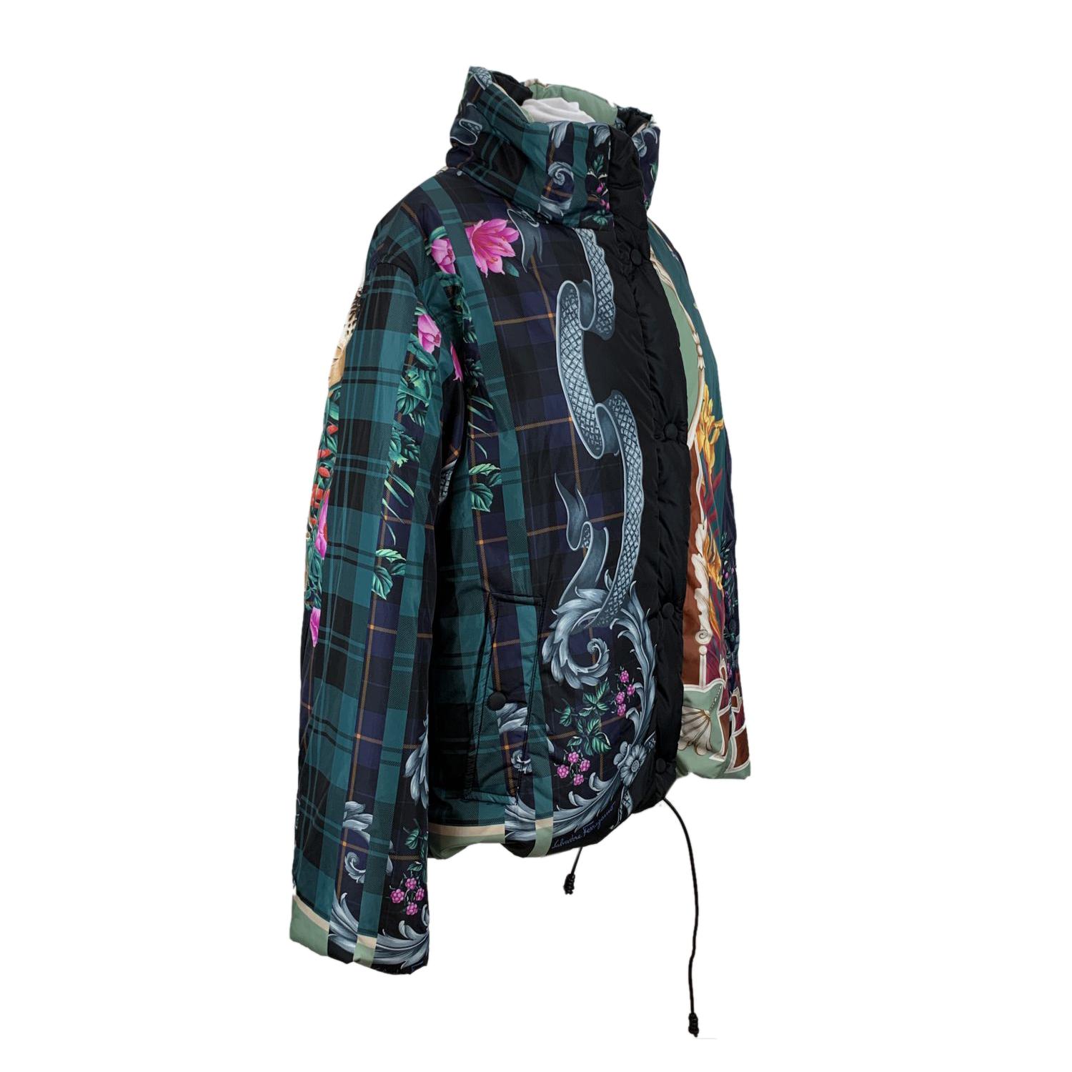 Salvatore Ferragamo multi print puffer jacket. It features a stand up collar, button closure on the front, long sleeve styling and a drawstring hem. 2 pockets on the waist. Composition: 100% Polyamide. Filling: 100% Polyester. Size: 44 IT (The size