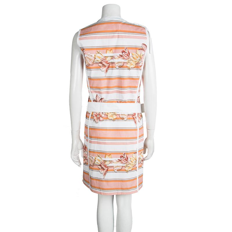 Simple and sophisticated is what defines this sleeveless dress from Salvatore Ferragamo. The Italian dress is made of a cotton blend and features a lovely multicolor floral and stripe print pattren all over it. With a wrap style silhouette, it comes
