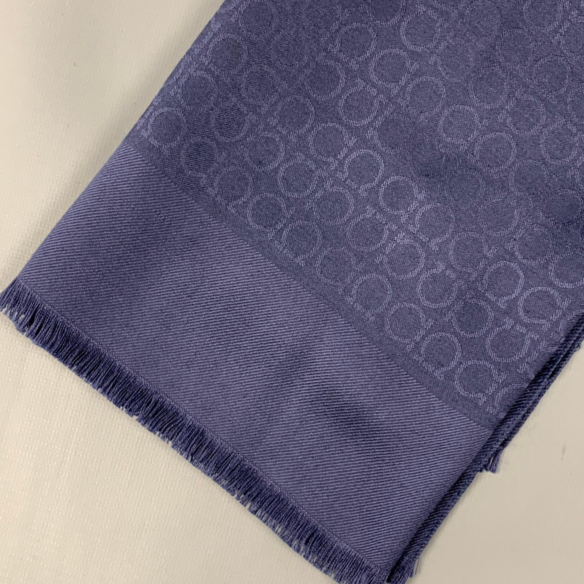 SALVATORE FERRAGAMO scarf comes in a navy logo print wool / silk with a fringe trim. Made in Italy. 

Very Good Pre-Owned Condition.
Original Retail Price: $340.00

Measurements:

70 in. x 28 in. 