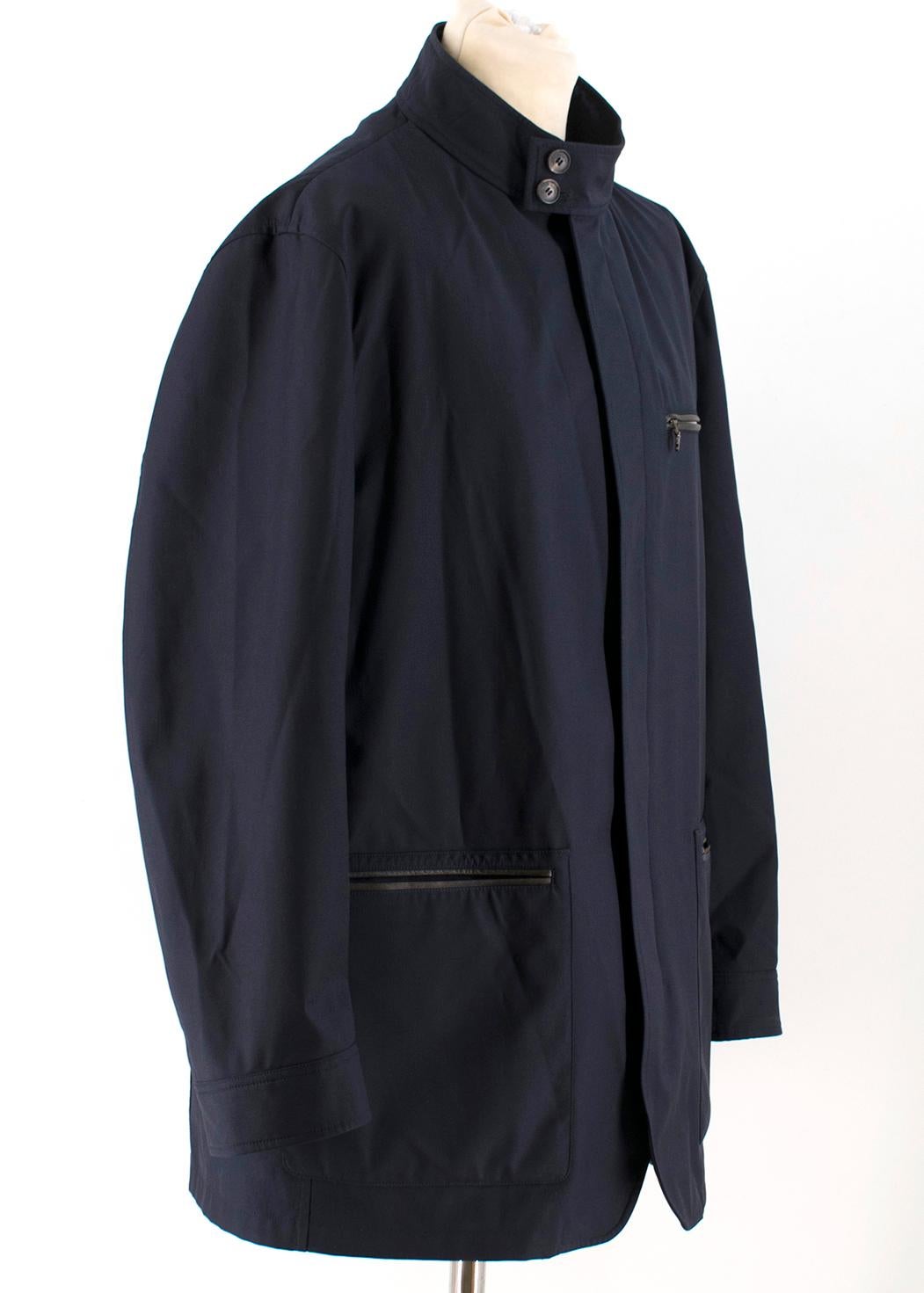 Salvatore Ferragamo Navy Padded Trench Coat  

- Navy medium length coat made in technical fabric
- The coat has removable padded vest with zip fastening
- Zip closure
- Two button fastening of collar stand
- Cotton Collar insert inside
- Two large