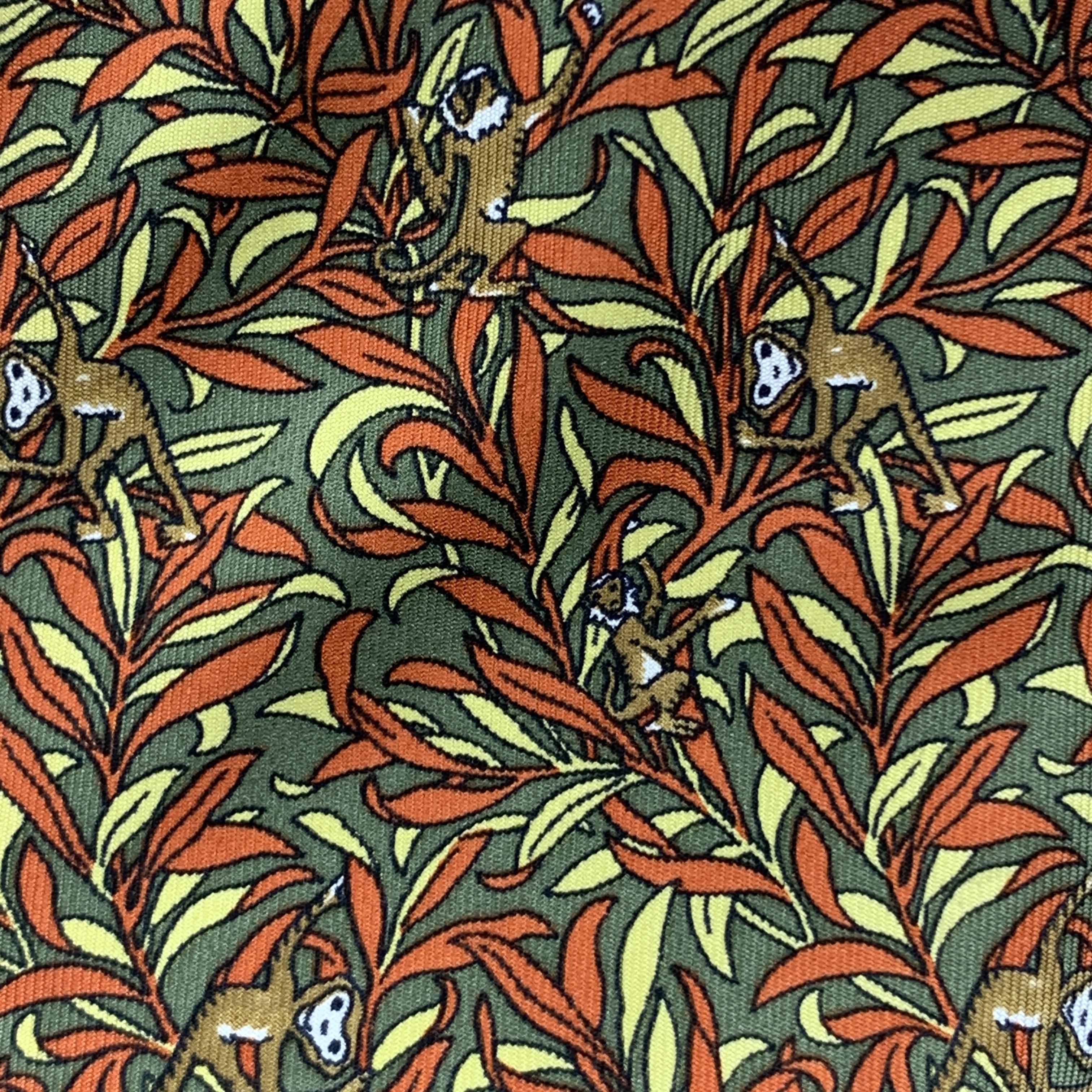 SALVATORE FERRAGAMO necktie comes in olive green and burnt orange pattern silk twill with all over monkeys print. Made in Italy.

Very Good Pre-Owned Condition.

Width: 3.5 in.
