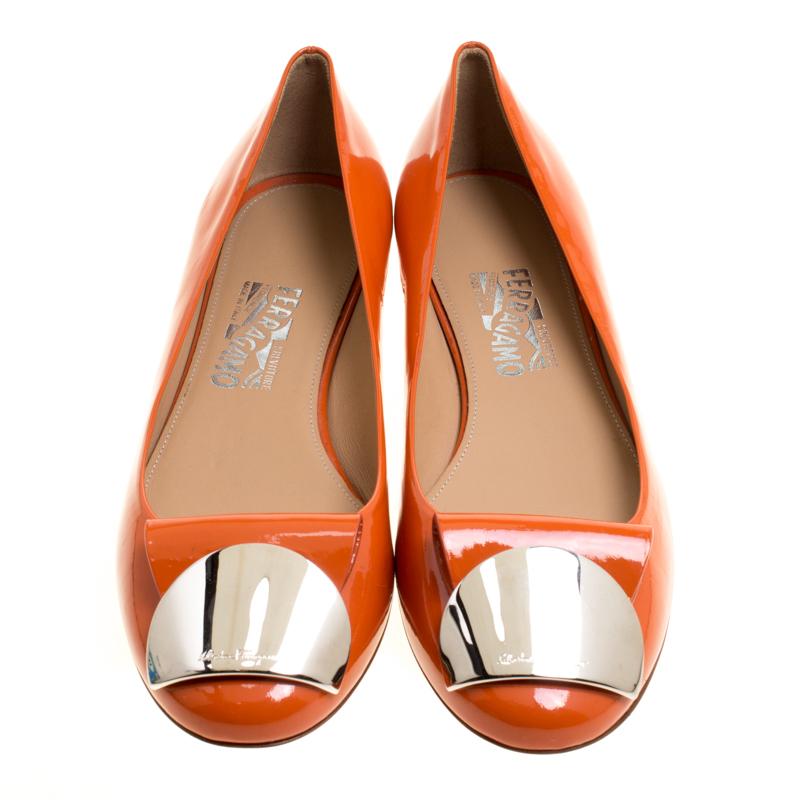Walk with style and comfort in these Posi flats from Salvatore Ferragamo. Crafted from leather in Italy, these orange flats carry round toes, leather insoles and engraved metal accents on the uppers. They are complete with the brand label on the