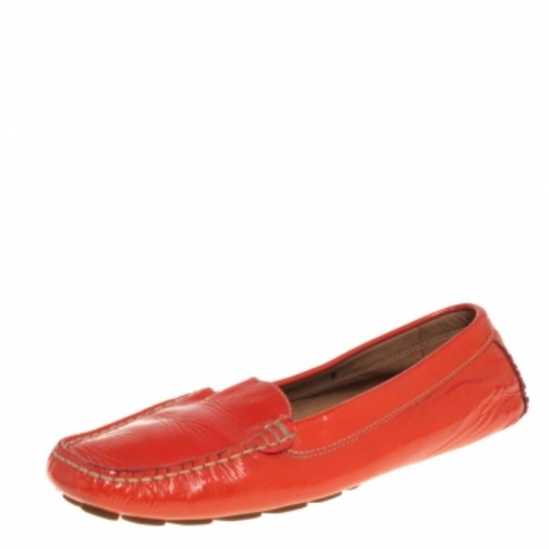 Project an ultra-stylish look in these orange loafers from Salvatore Ferragamo! They have been crafted from patent leather and designed with round toes and neat stitches all over. They are complete with comfortable leather-lined insoles and durable