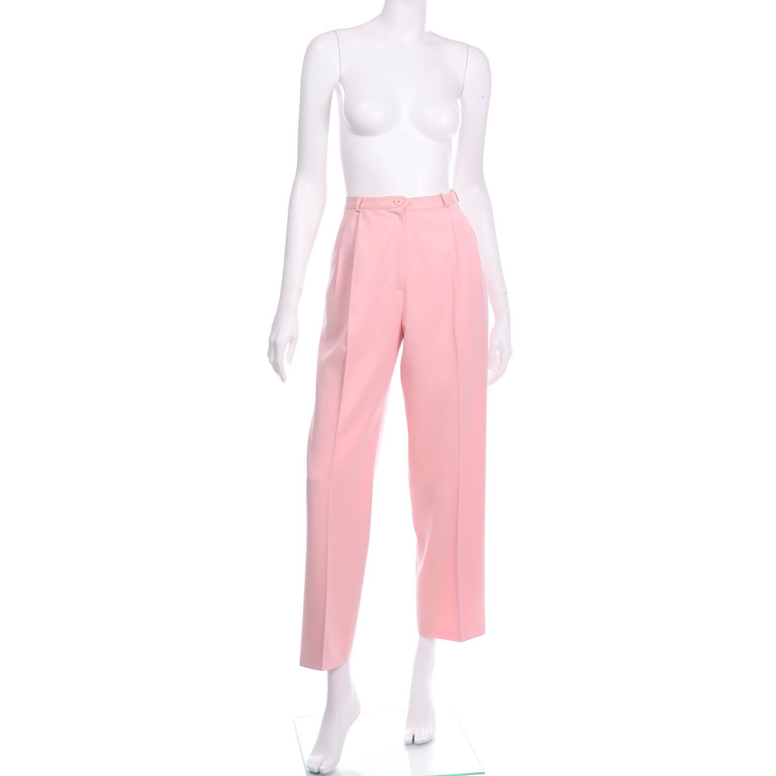 These vintage Salvatore Ferragamo pink wool trousers have sleek pleated straight leg and would fit in to any modern wardrobe. The pants have a waistband with small belt loops and  two front pleats with a pressed center pleat down the leg to the hem.