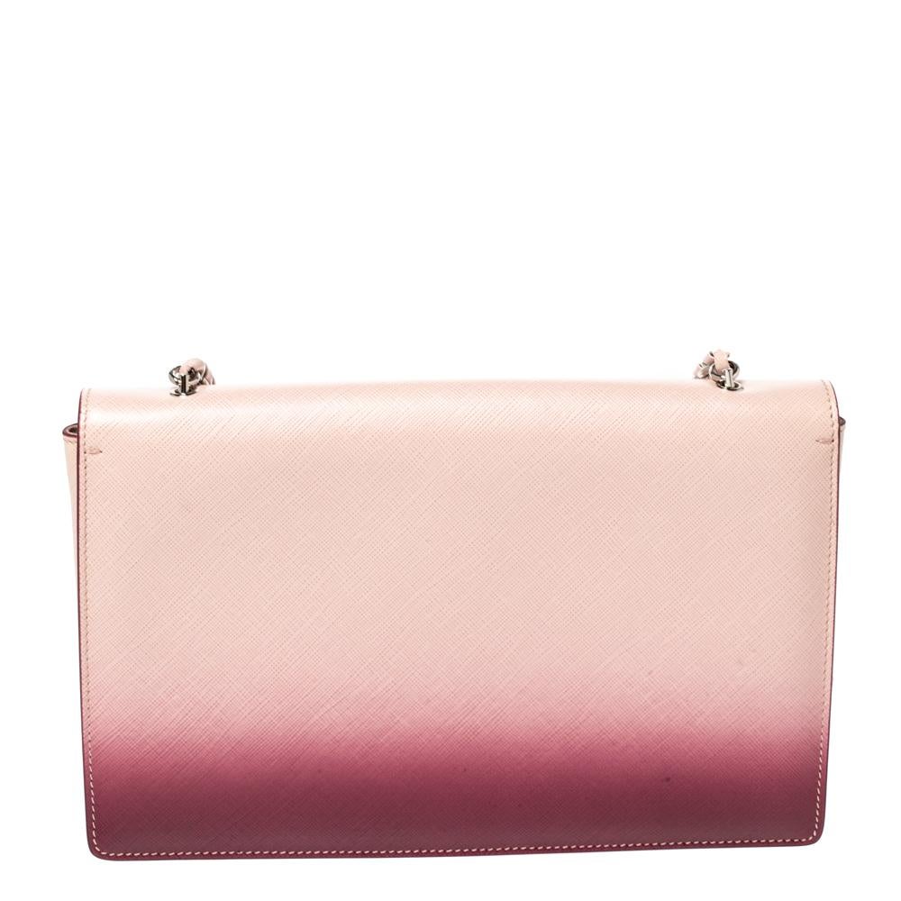 Lift up your mood and look extremely graceful every time you walk out the door with this finely created leather bag by Salvatore Ferragamo. The satin interior is well-sized and the signature bow on the front adds to its beauty. This pink and