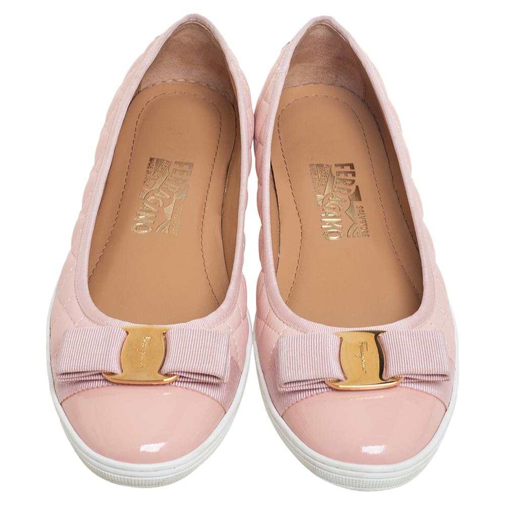 Give your feet the luxurious treatment with these dainty slip-on sneakers designed by Salvatore Ferragamo. They are crafted from pink quilted and patent leather into a sleek silhouette. They are finished with pretty bow details on the vamps and
