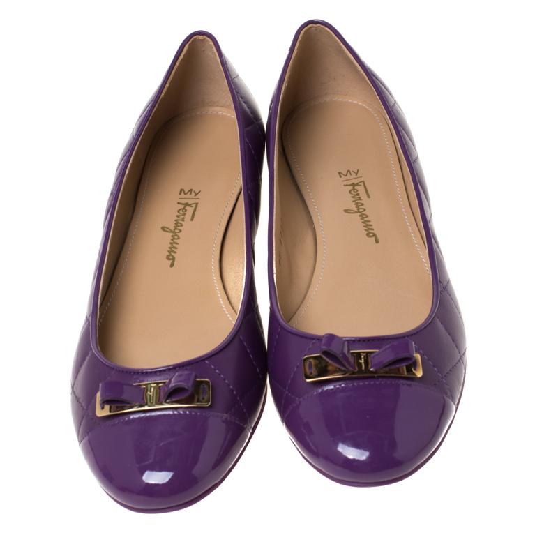 A common sight in the closets of fashionistas is a pair of Salvatore Ferragamo ballet flats. They are perfect to wear on an evening out and just stylish enough to assist one's style. These are crafted from purple quilted leather and feature bows on