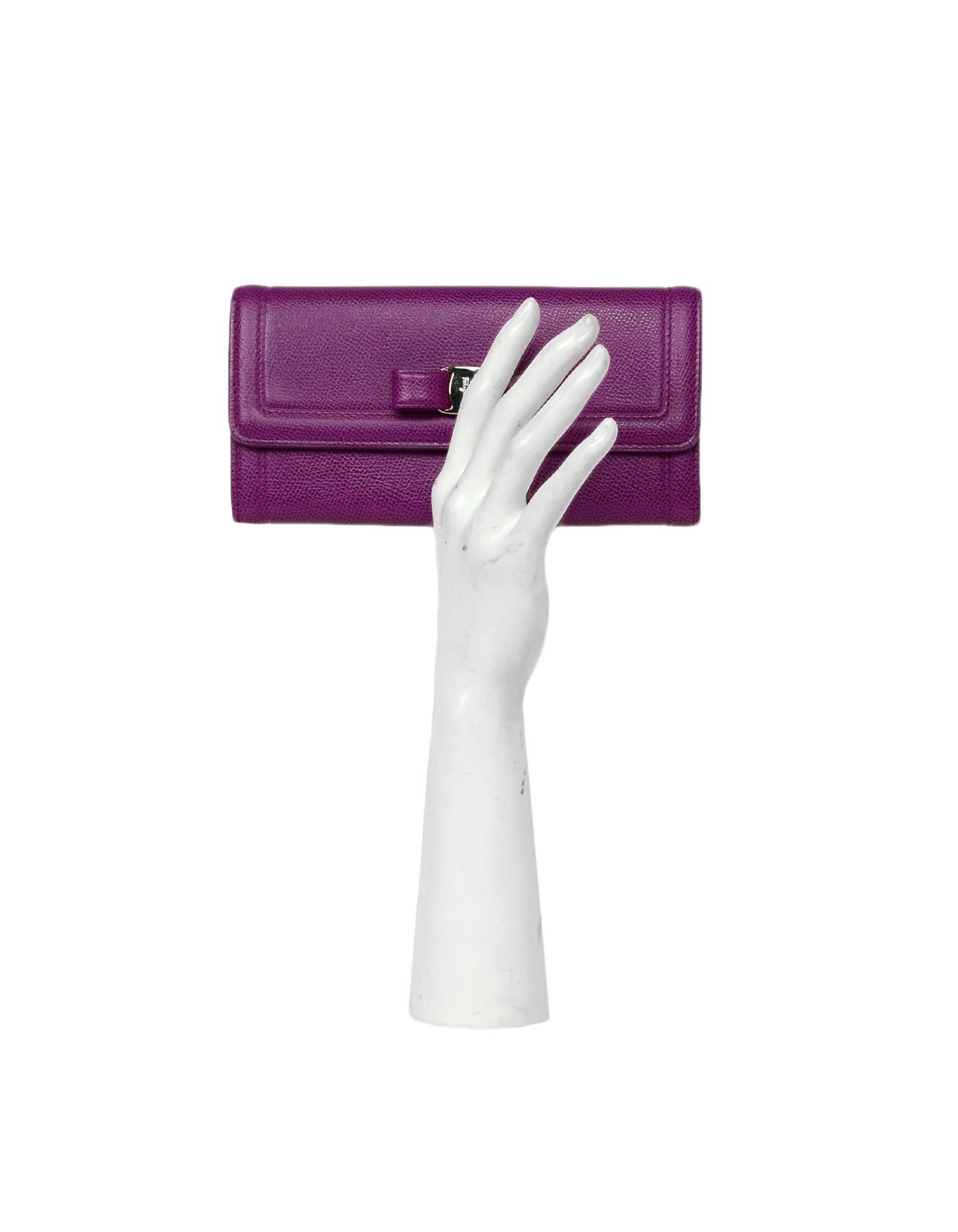 Ferragamo Purple Textured Leather Vera Bow Wallet 

Made In: Italy
Color: Purple
Hardware: Goldtone
Materials: Leather
Lining: Purple fine textile
Closure/Opening: Top flap with snap closure
Exterior Pockets: None
Interior Pockets: Three flat