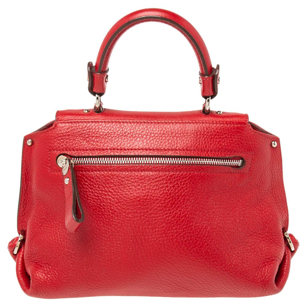This timeless Sofia bag from Salvatore Ferragamo is both elegant and fashionable. Crafted from red leather, this bag features a silver-toned lock embellishment on the front and a top handle. It reveals a fabric-leather interior and has an additional