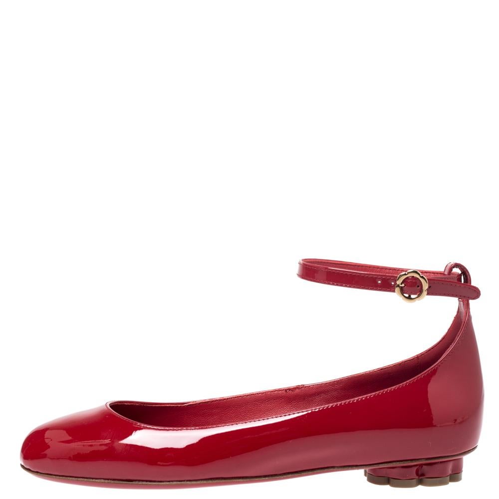These magnificent flats from Salvatore Ferragamo are designed to complement your entire outfit. They are crafted from patent leather and designed with flower heels and ankle straps. Let these red beauties speak for themselves in terms of style and