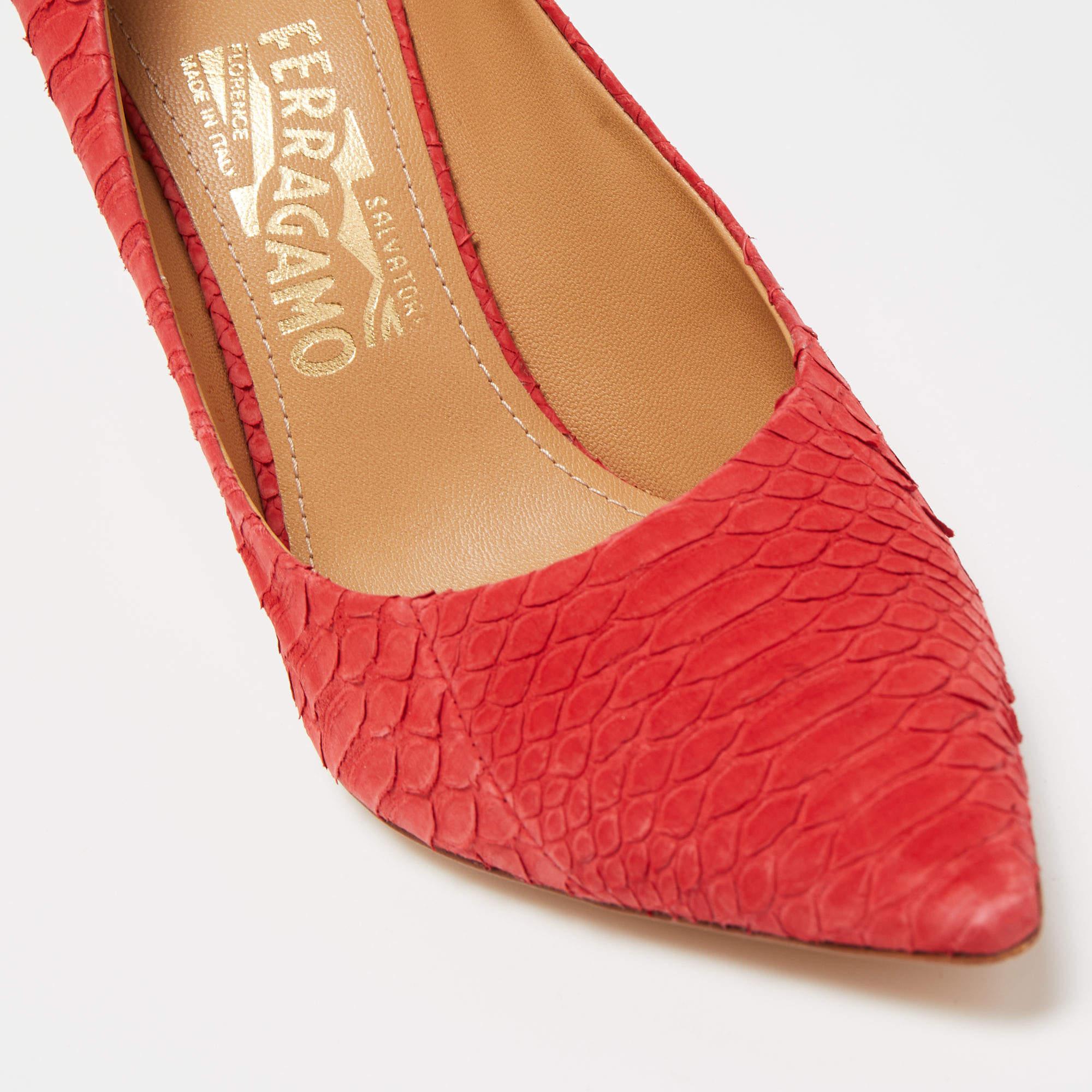 The Salvatore Ferragamo pumps are luxurious and stylish women's shoes. Crafted with red python skin, they feature a pointed-toe design, and a slim stiletto heel, exuding timeless elegance and sophistication.

