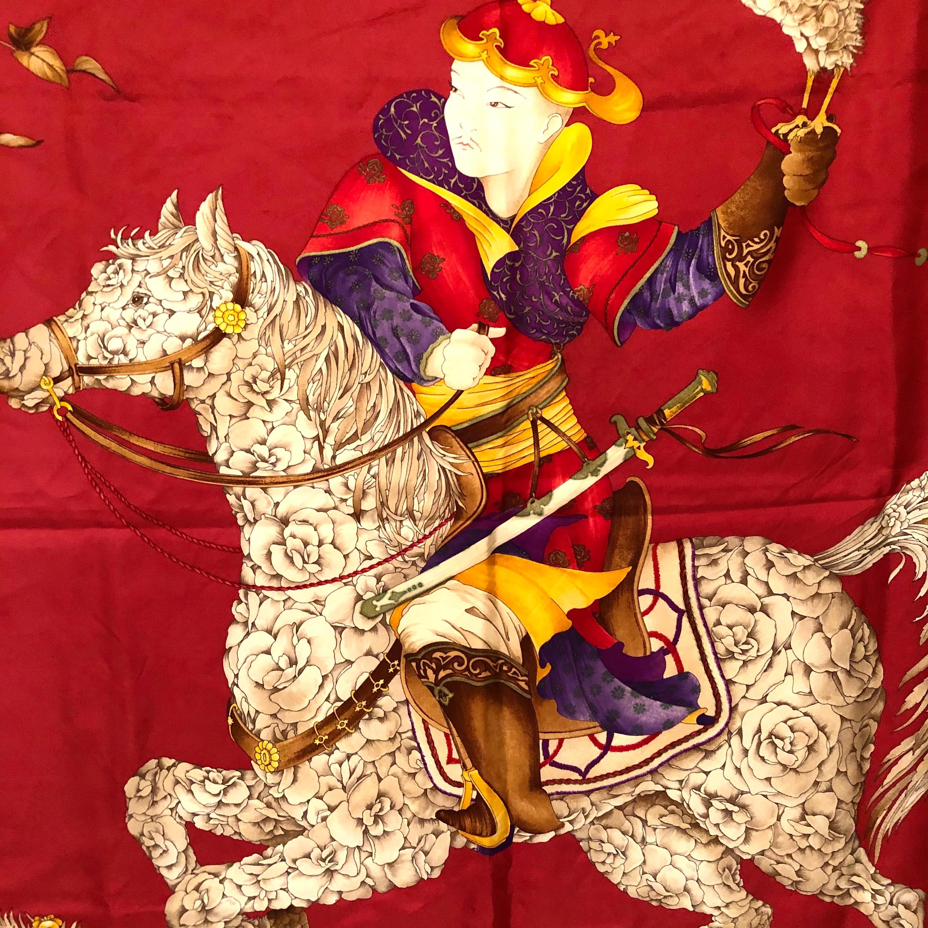 Salvatore Ferragamo red silk scarf with a man on a beautiful horse with a bird on his hand. The design on this scarf is eye catching and wonderful. This would make a beautiful addition to any fashion ensemble. It would also be a fabulous scarf to