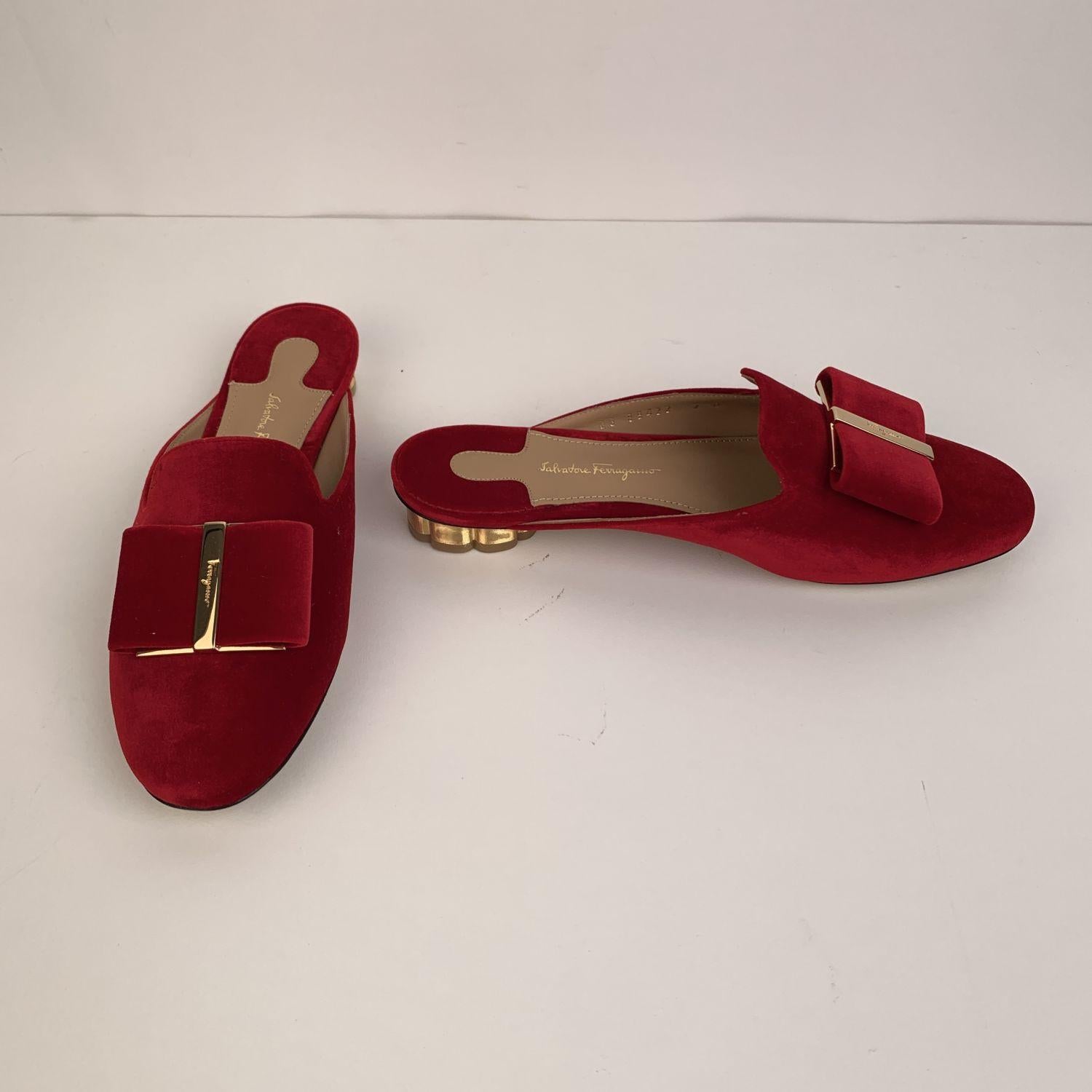 Sophisticated Salvatore Ferragamo 'Sciacca T' mules. Crafted in red velvet, they feature a lip-on design, round toe, red velvetl Vara-bow detailing on the toes and gold metal block flower-shaped low heel (height: 1 cm). Leather sole. Lightly padded