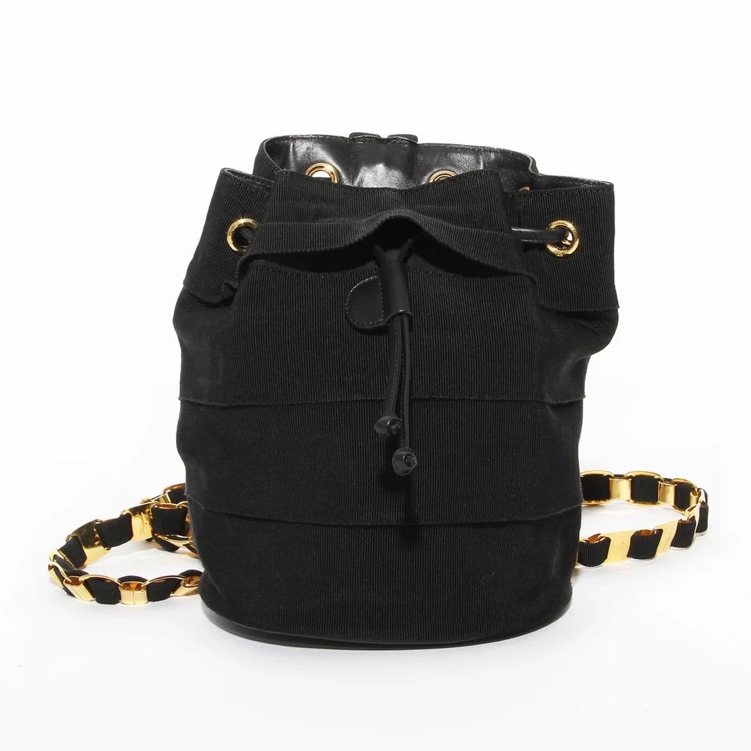 Salvatore Ferragamo Backpack
Made in Italy 
Black tiered grosgrain ribbon 
Gold grommets along top of bag
Black leather drawstring 
Black leather bottom 
Interior gold ball hook closure 
Leather along the top interior 
Inside pocket with zipper