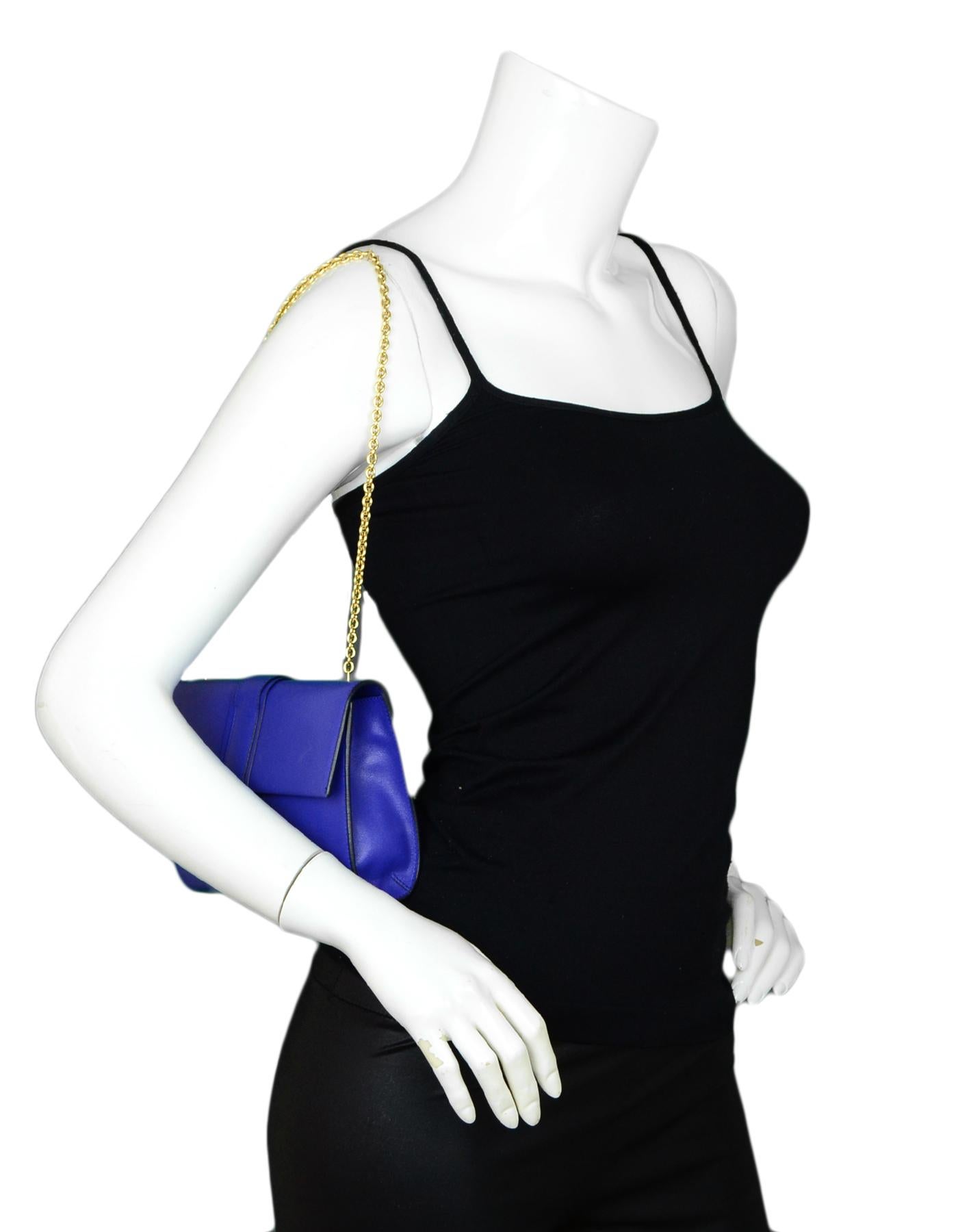 Salvatore Ferragamo Royal Blue Leather Gancini Flap Bag w/ Chain Strap

Made In: Italy
Color: Royal blue
Hardware: Goldtone hardware
Materials: Leather
Lining: Black textile lining
Closure/Opening: Top flap with Gancini flap lock
Exterior Pockets: